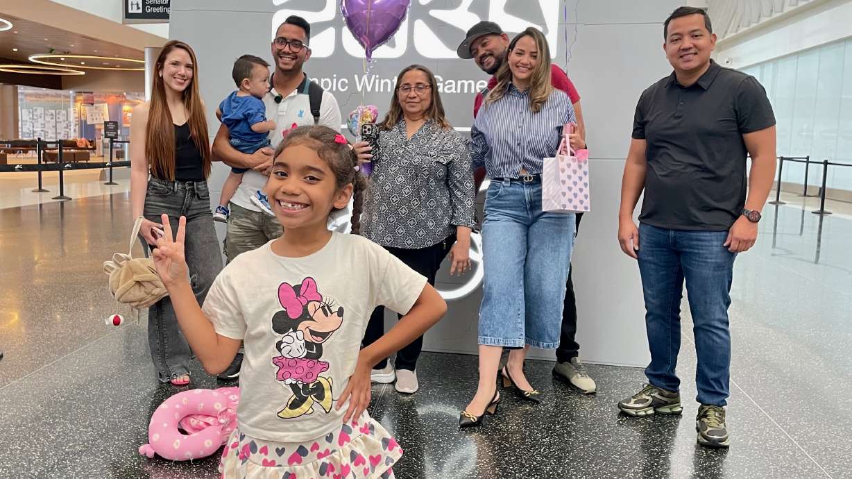 Lucia Bermudez Prado, a Utah girl who was stuck in Colombia with her father, returned home on Friday after U.S. officials reversed an earlier decision to deny her a visa. She's pictured with family at Salt Lake City International Airport.