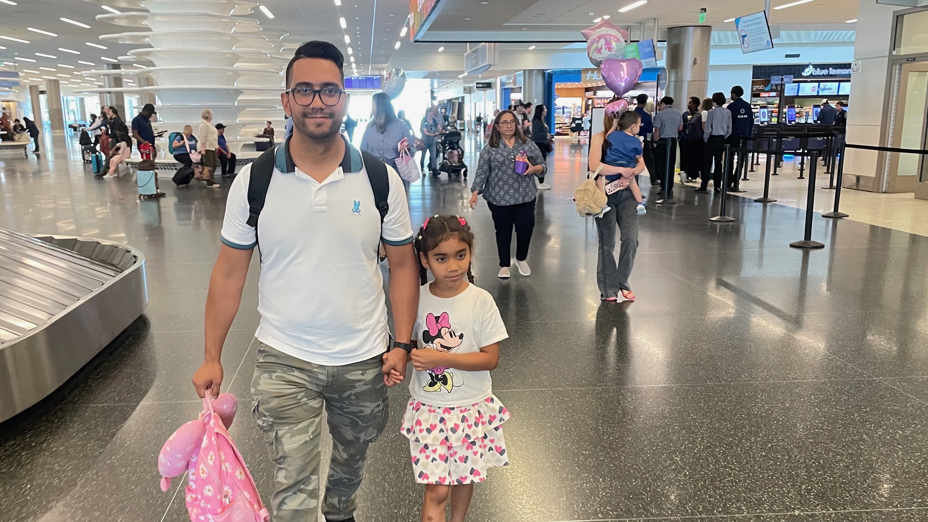 Lucia Bermudez Prado, a Utah girl who was stuck in Colombia with her father, Leandro Bermudez, returned home on Friday after U.S. officials reversed an earlier decision to deny her a visa. They are pictured at Salt Lake City International Airport.