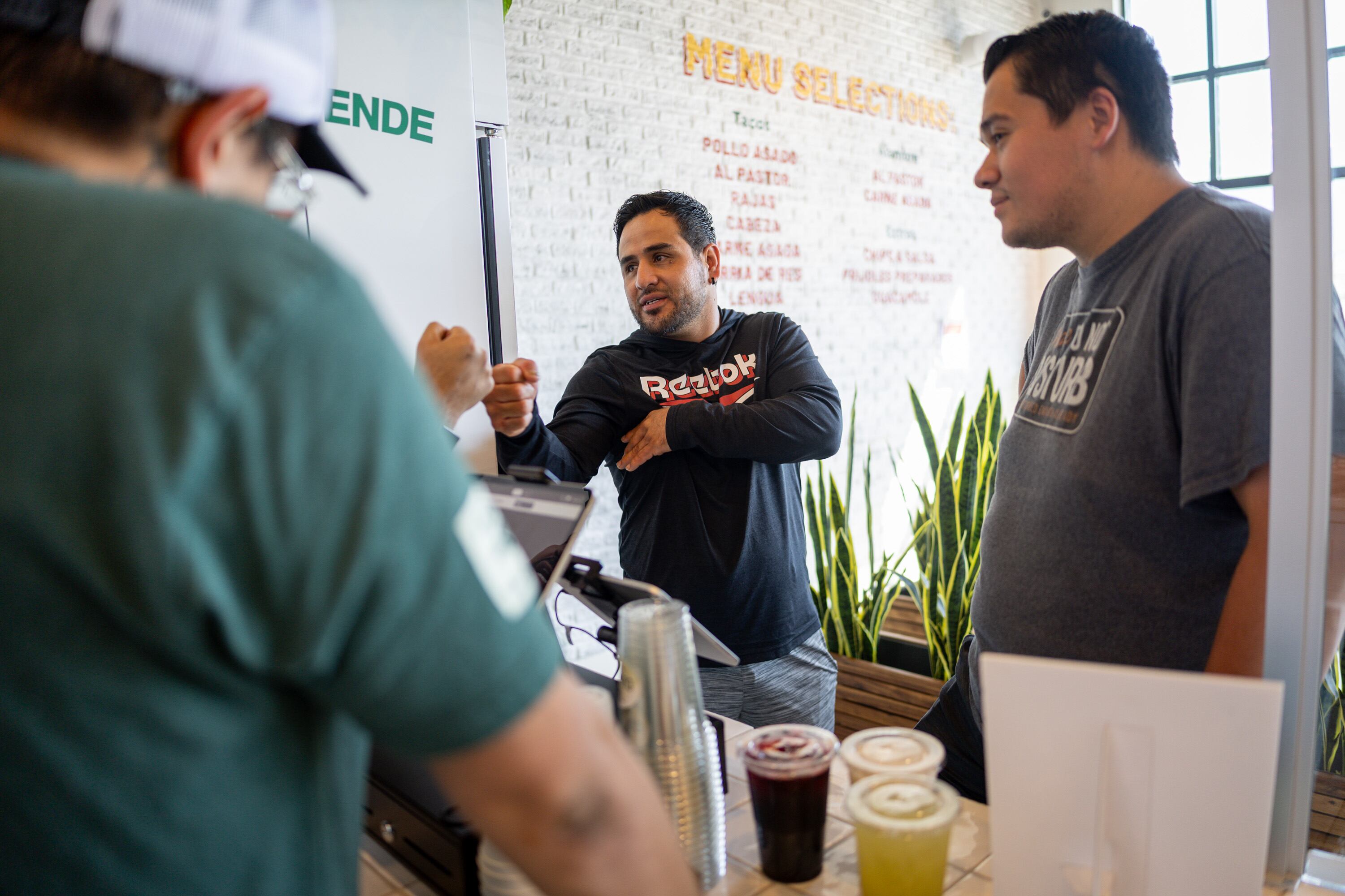 Customers Giovanni Munoz, right, and Armando Cano, left, order at Taco Culture  in American Fork on May 8.