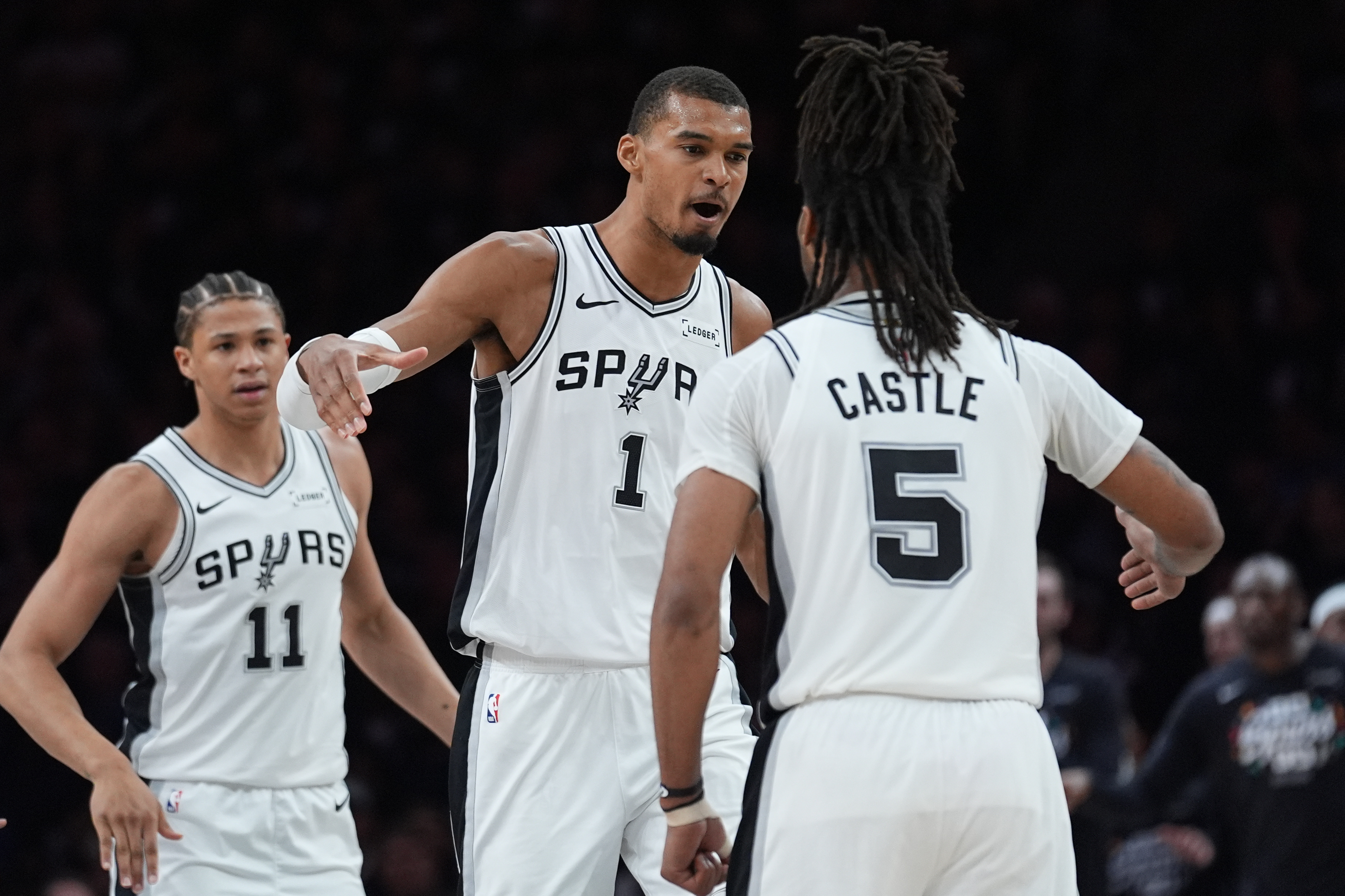 San Antonio Spurs forward Victor Wembanyama (1) celebrates a score with guard Stephon Castle (5) during the first half of Game 6 of an NBA basketball second-round playoffs series in Minneapolis, Friday, May 15, 2026. 