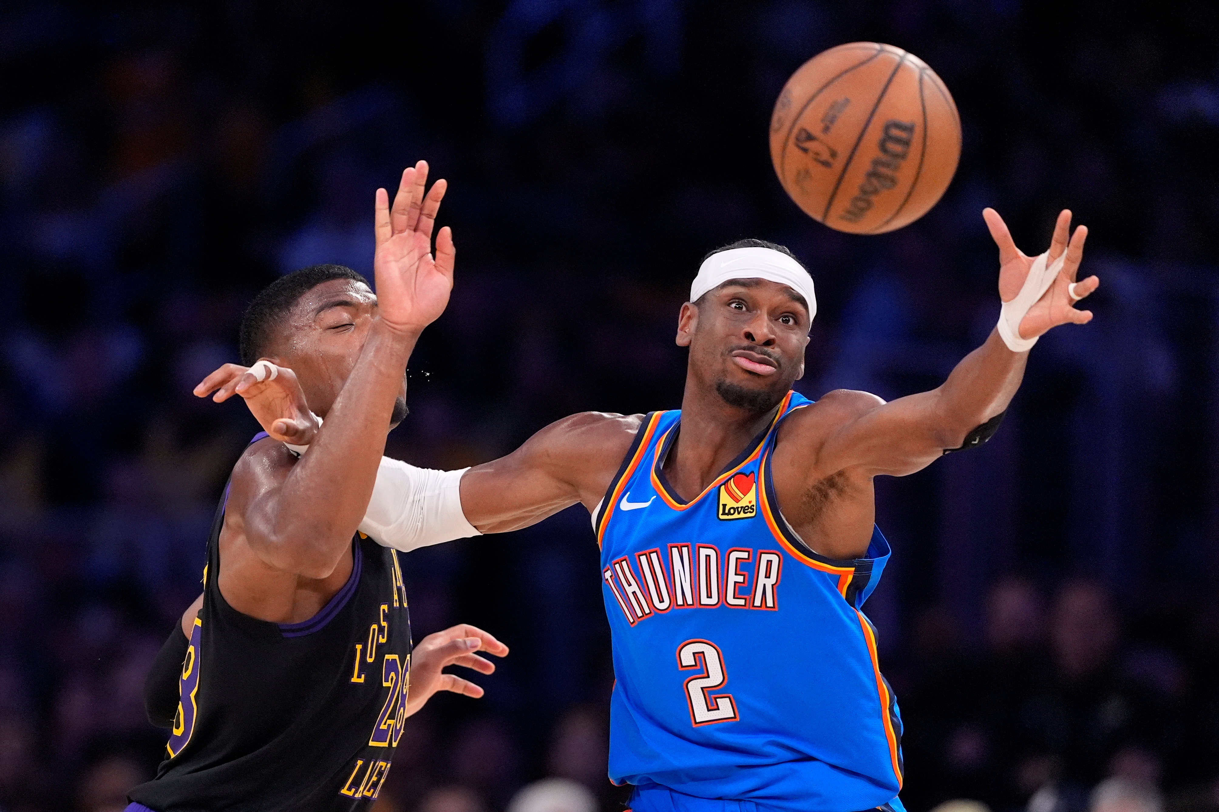 Oklahoma City Thunder guard Shai Gilgeous-Alexander, right, takes a pass while under pressure from Los Angeles Lakers forward Rui Hachimura during the first half of Game 4 in a second-round NBA basketball playoffs series Monday, May 11, 2026, in Los Angeles. 