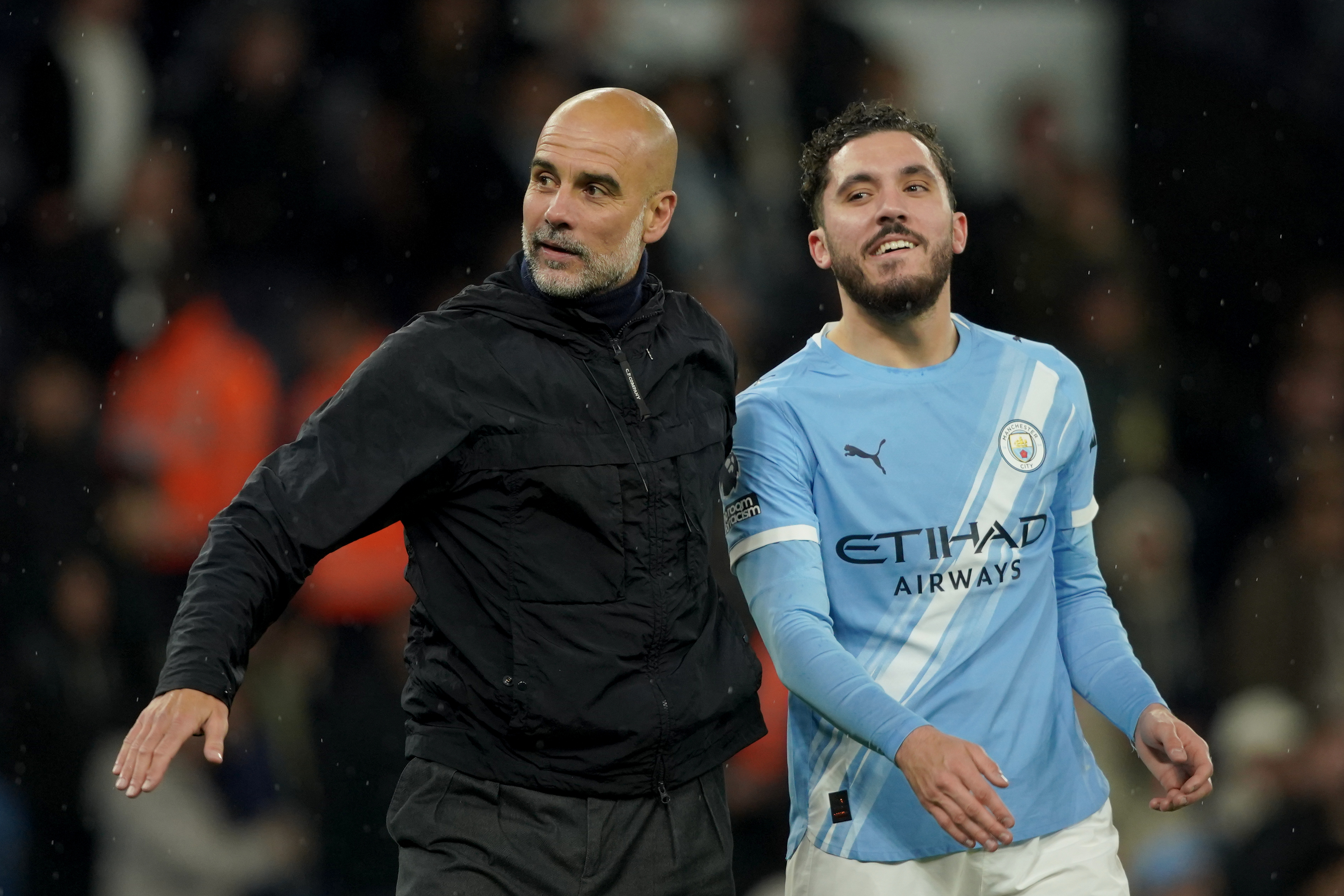 Manchester City's head coach Pep Guardiola, left, celebrates with Manchester City's Rayan Cherki at the end of the English Premier League soccer match between Manchester City and Crystal Palace in Manchester, England, Wednesday, May 13, 2026. 