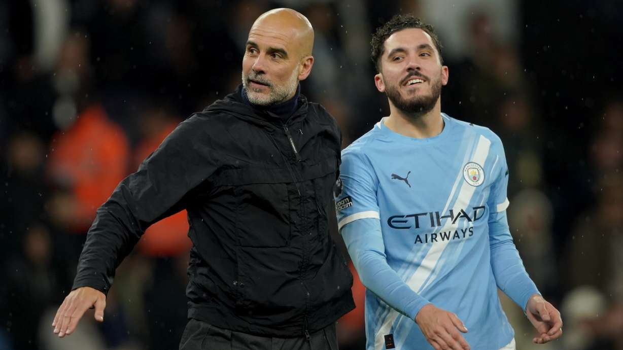Manchester City's head coach Pep Guardiola, left, celebrates with Manchester City's Rayan Cherki at the end of the English Premier League soccer match between Manchester City and Crystal Palace in Manchester, England, Wednesday, May 13, 2026.