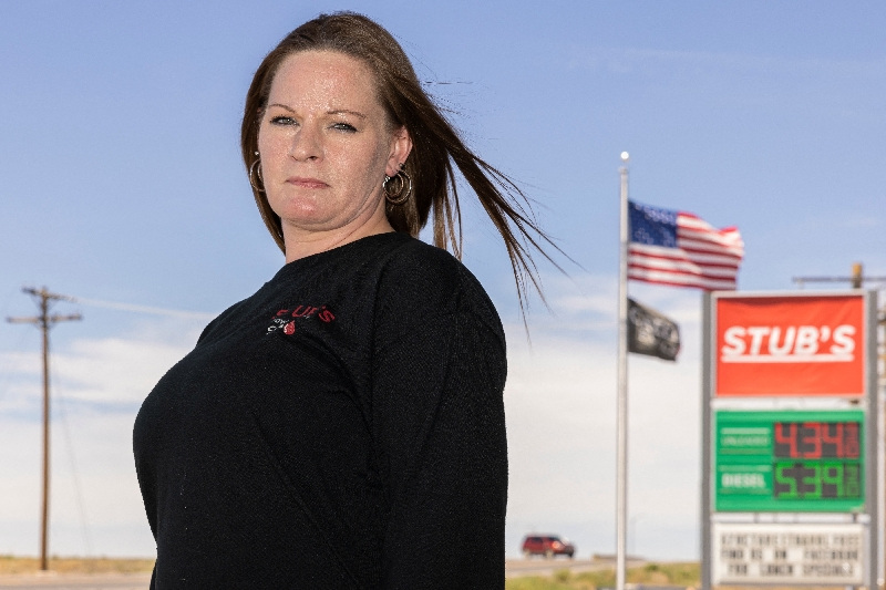 Amy Van Duyn stands for a portrait outside the gas station where she works in Wiggens, Colorado, May 11.