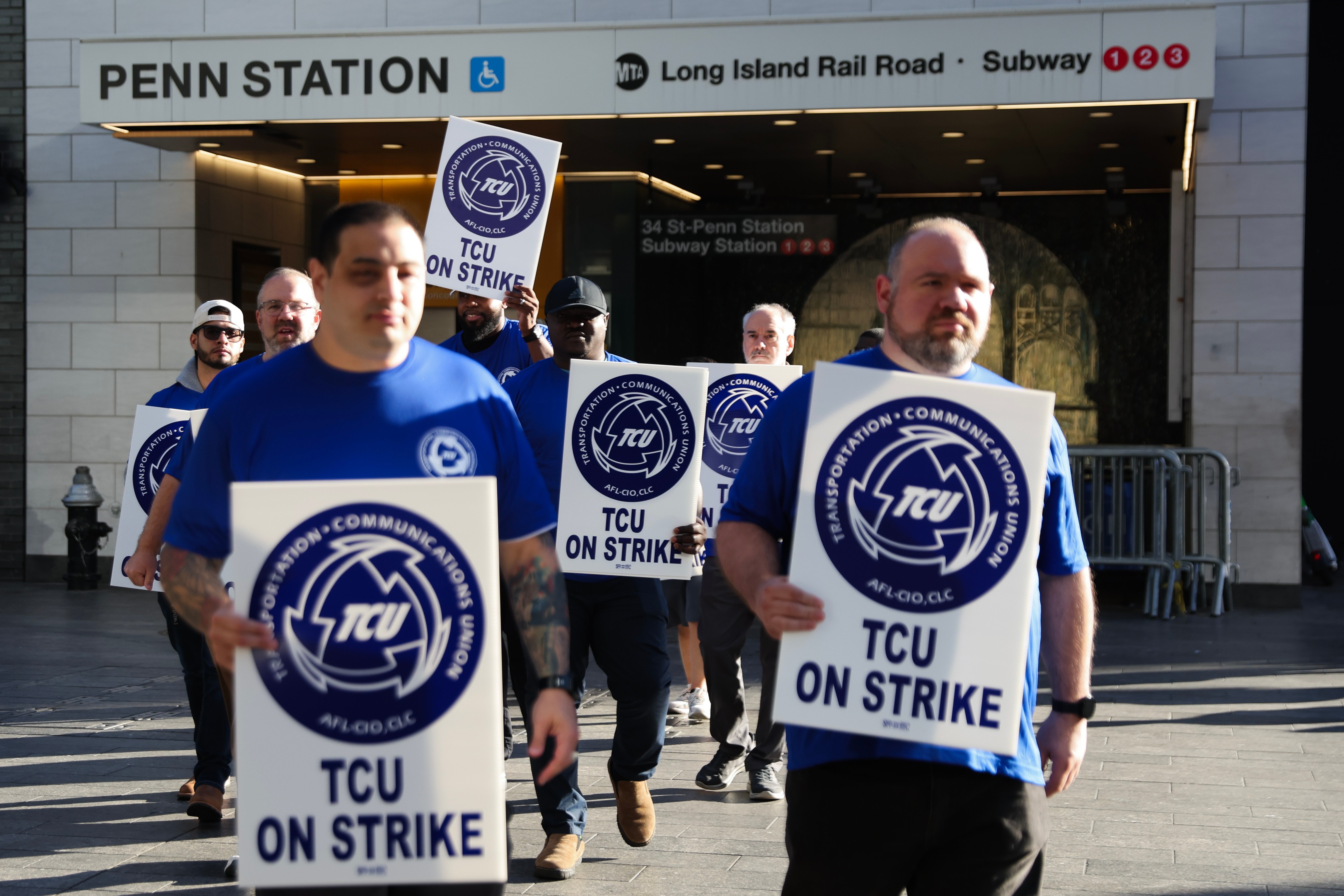 Long Island Rail Road workers walk on the picket line outside of Penn Station on the first day of their strike, Saturday, in New York. An engineer for the railroad told The Associated Press it's likely President Donald Trump or Congress will step in to end the strike.