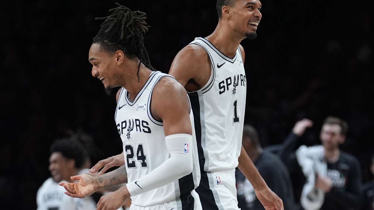San Antonio Spurs guard Devin Vassell (24) and forward Victor Wembanyama (1) celebrate a score against the Minnesota Timberwolves during the first half of Game 6 of an NBA basketball second-round playoffs series in Minneapolis, Friday, May 15, 2026.