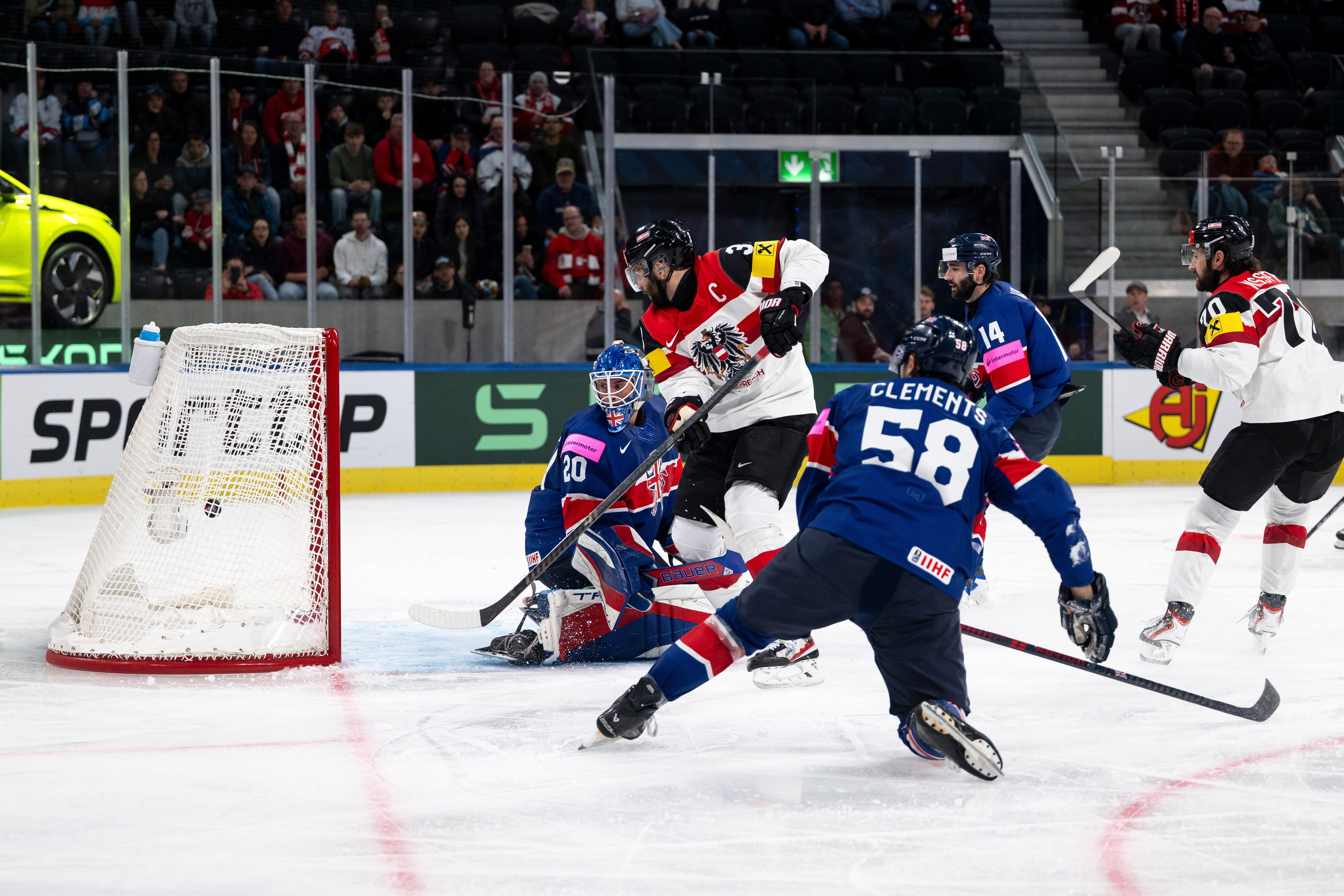 Austria's Peter Schneider, 2nd from left, scores his side's fourth goal past Britain's goaltender Mat Robson, during the 2026 IIHF Men's Ice Hockey World Championship preliminary round group A game between Britain and Austria, in Zurich, Switzerland, Saturday, May 16, 2026. 
