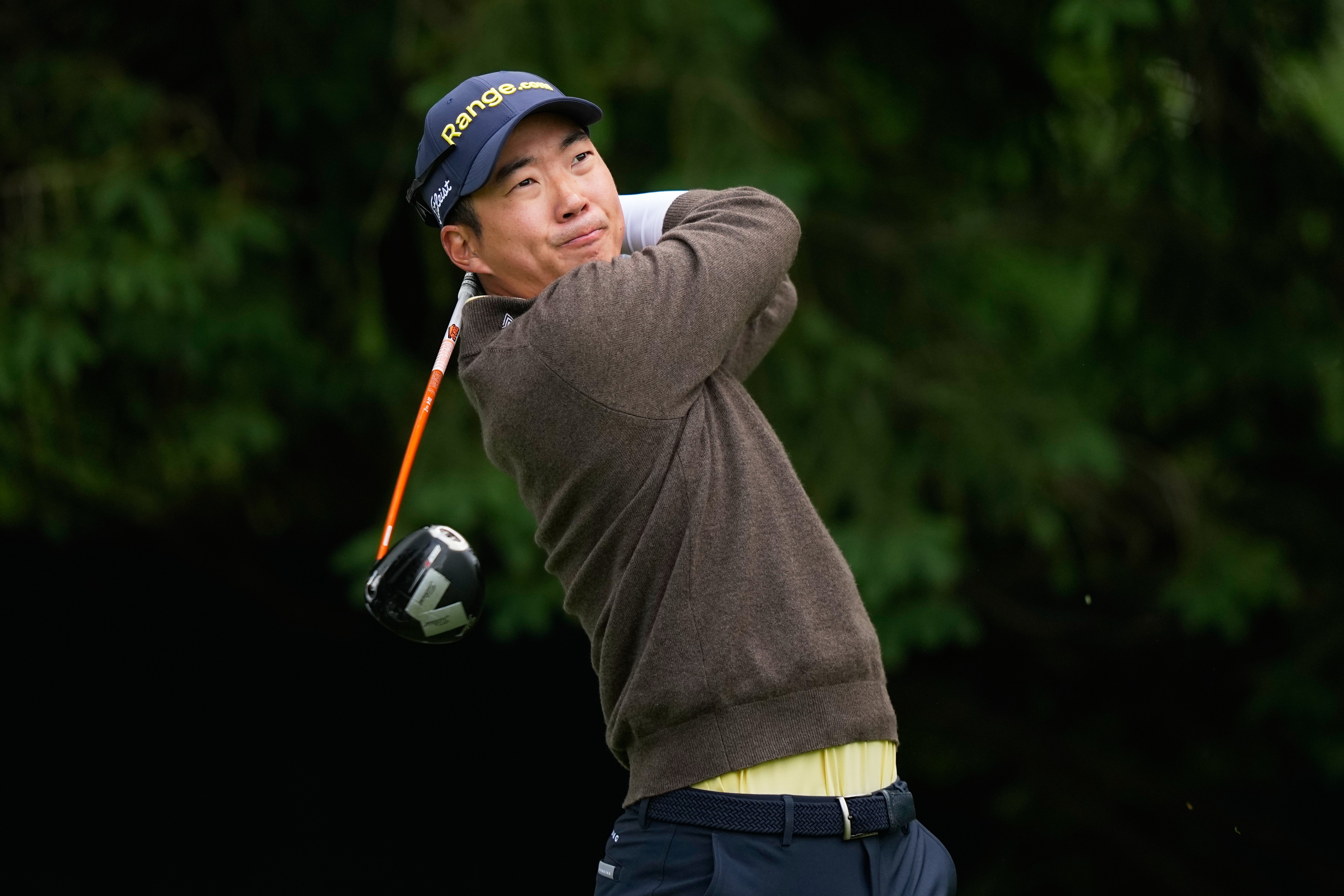 Michael Kim, of South Korea, watches his tee shot on the fourth hole during the first round of the PGA Championship golf tournament practice round at Aronimink Golf Club, Thursday, May 14, 2026, in Newtown Square, PA. 