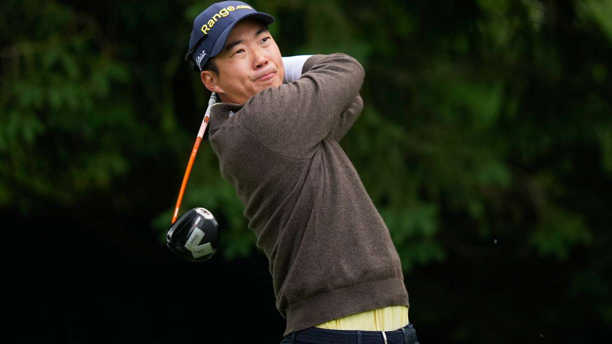 Michael Kim, of South Korea, watches his tee shot on the fourth hole during the first round of the PGA Championship golf tournament practice round at Aronimink Golf Club, Thursday, May 14, 2026, in Newtown Square, PA.