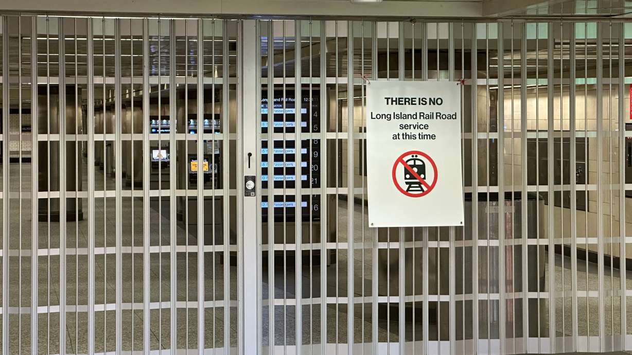 A gate blocks a corridor to Long Island Rail Road train platforms at Penn Station on the first day of a strike on Saturday in New York. The railroad shut down after five unions, representing half the rail's workforce, walked off the job.