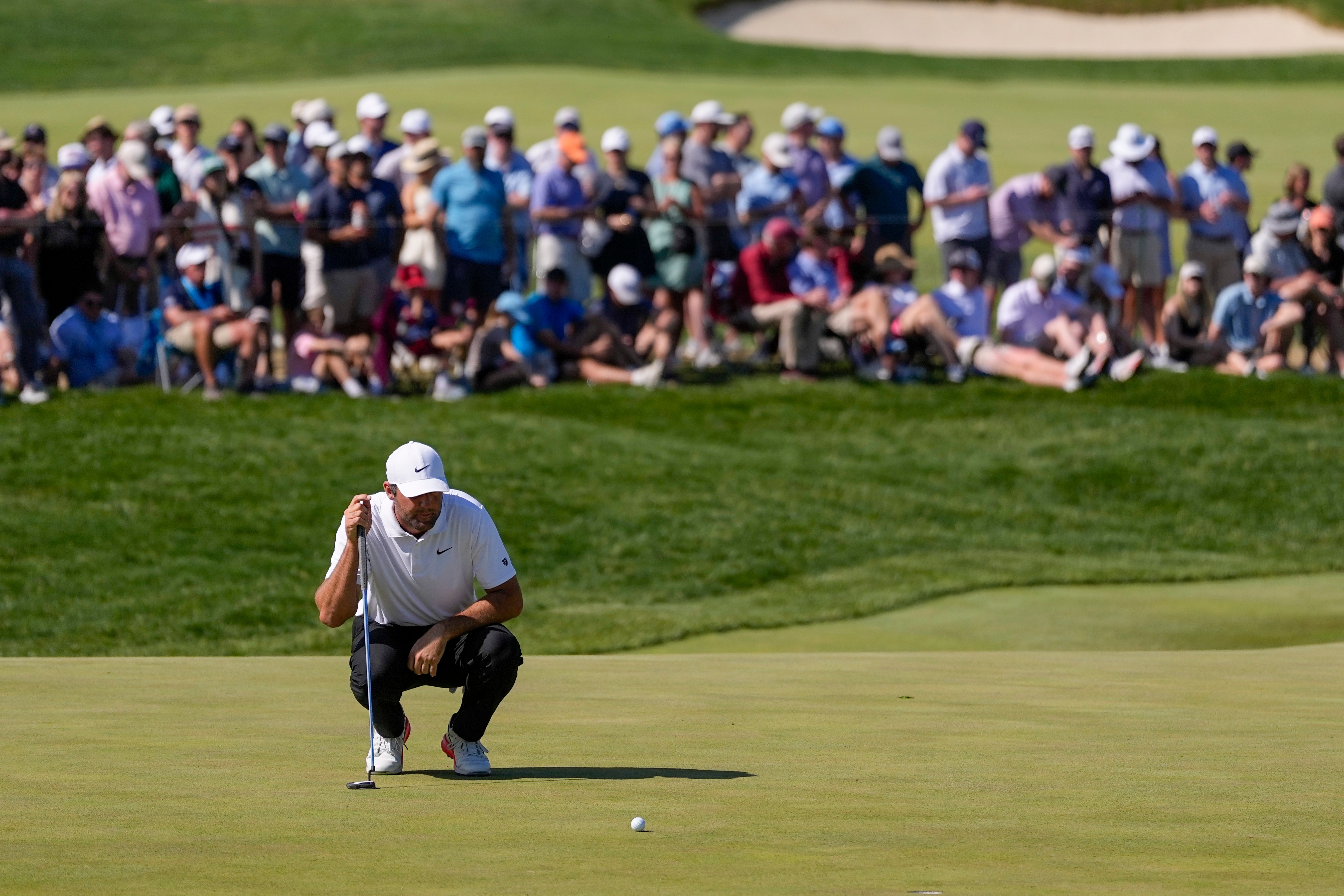 Scottie Scheffler lines up his shot on the 10th green during the third round of the PGA Championship golf tournament at Aronimink Golf Club, Saturday, May 16, 2026, in Newtown Square, PA. 
