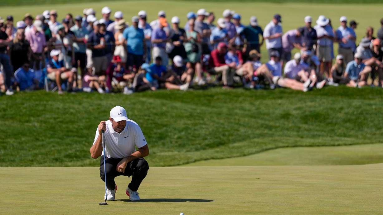 Scottie Scheffler lines up his shot on the 10th green during the third round of the PGA Championship golf tournament at Aronimink Golf Club, Saturday, May 16, 2026, in Newtown Square, PA.