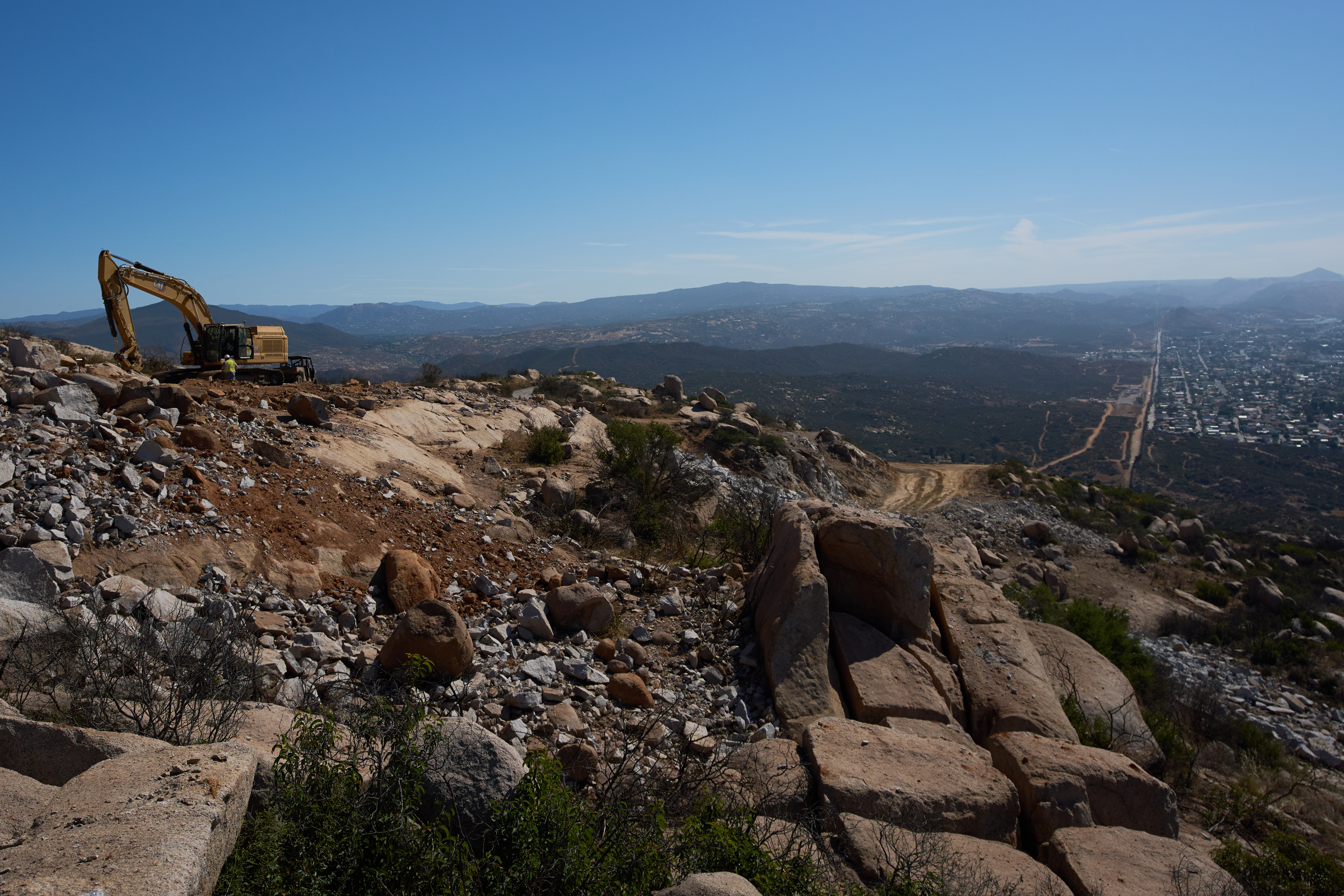 Construction crews work on a new border wall segment on Kuuchamaa Mountain, April 24, seen from Tecate, Mexico. 