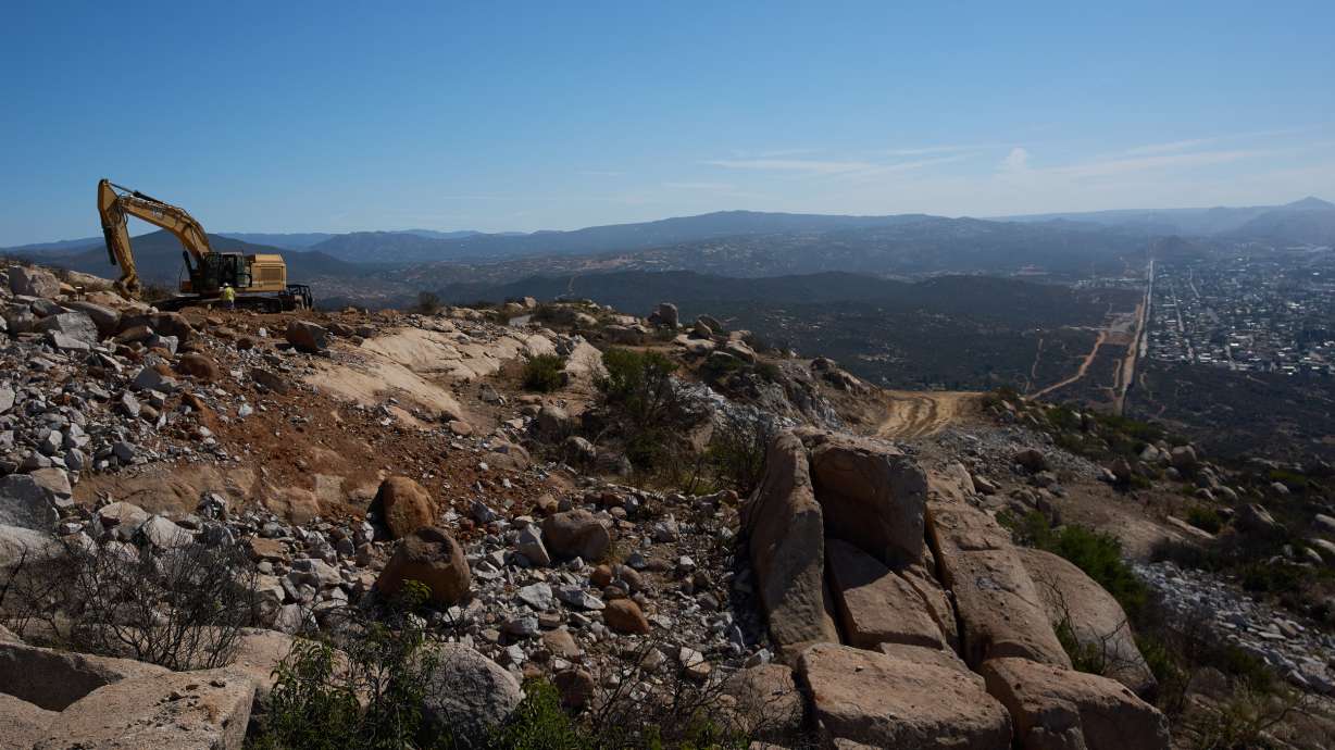 Construction crews work on a new border wall segment on Kuuchamaa Mountain, April 24, seen from Tecate, Mexico.