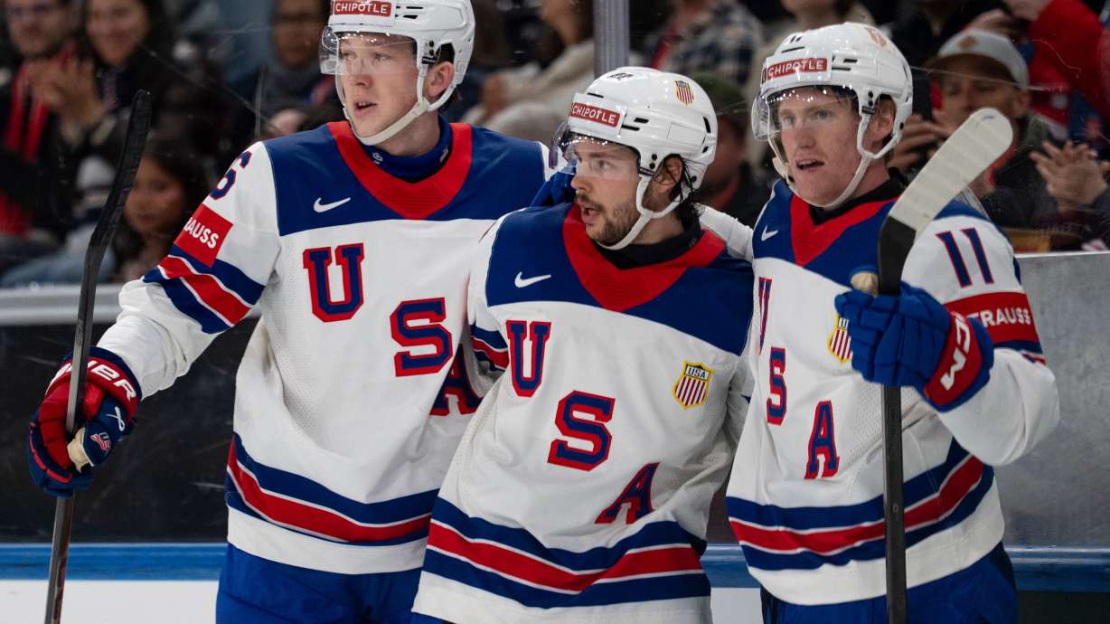 From left, USA's Mason Lohrei, Isaac Howard and Oliver Moore celebrate after their team's second goal, during the 2026 IIHF Men's Ice Hockey World Championship preliminary round group A game between Britain and the United States, in Zurich, Switzerland, Sunday, May 17, 2026.