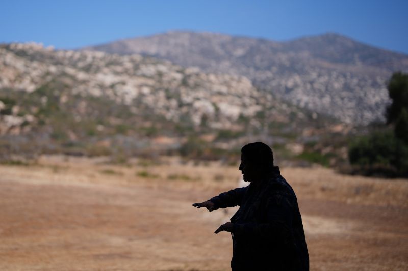 Norma Meza Calles, a Kumeyaay Nation leader, gestures as she speaks of the sacred importance of Kuuchamaa Mountain, behind, at a wellness center, May 1, in Tecate, Mexico.