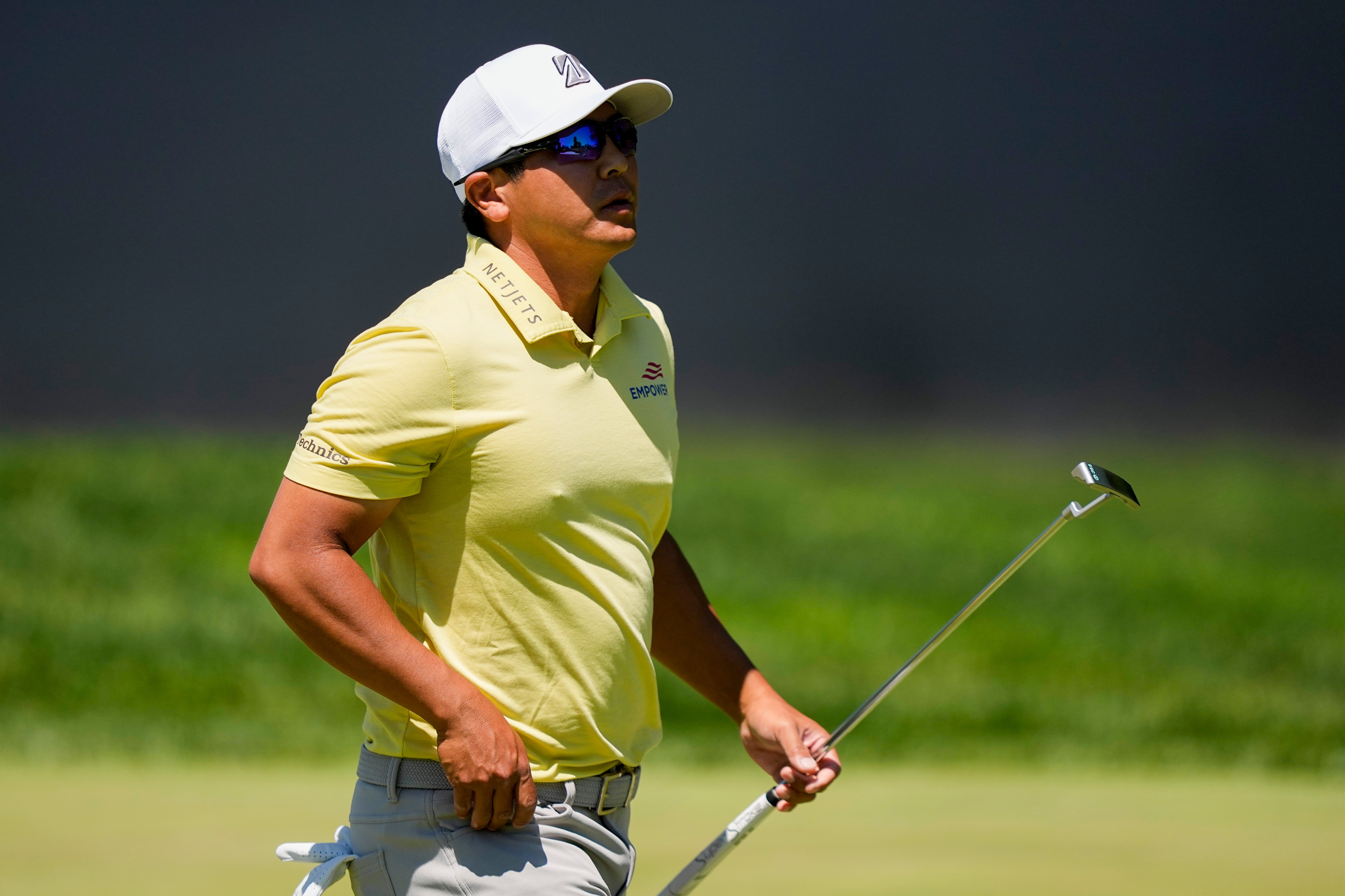 Kurt Kitayama walks across the first green after his shot during the third round of the PGA Championship golf tournament at Aronimink Golf Club, Saturday, May 16, 2026, in Newtown Square, PA. 