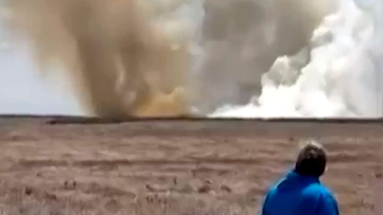 This still image taken from video shows a plume of smoke rises above the plain near Mountain Home Air Force Base, Idaho, where two Navy jets collided at an air show on Sunday.