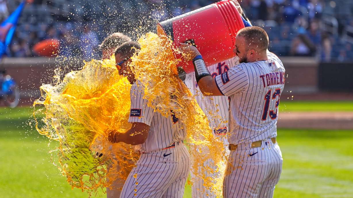 New York Mets' players dump a cooler on Tyrone Taylor, left, after a baseball game against the New York Yankees, Sunday, May 17, 2026, in New York.