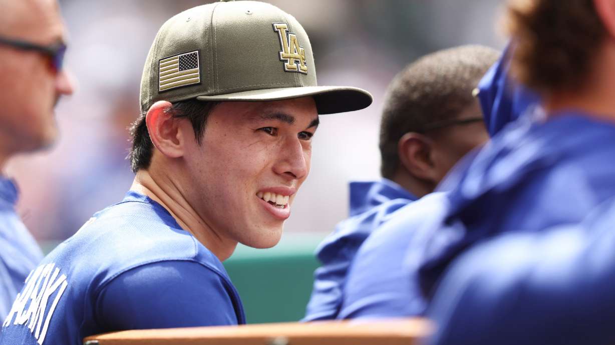 Los Angeles Dodgers pitcher Roki Sasaki reacts in the dugout during the eighth inning of a baseball game against the Los Angeles Angels, Sunday, May 17, 2026, in Anaheim, Calif.