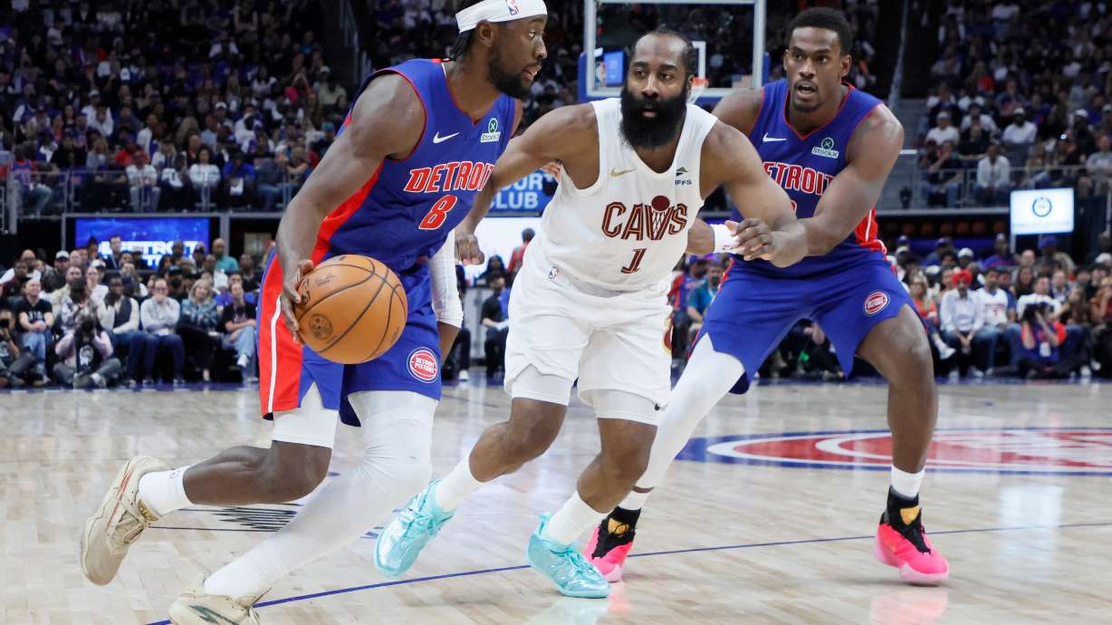 Detroit Pistons guard Caris LeVert (8) drives to the basket against Cleveland Cavaliers guard James Harden (1) with Pistons center Jalen Duren, right, helping on the play during the first half in Game 7 of a second-round NBA playoffs basketball series Sunday, May 17, 2026, in Detroit.