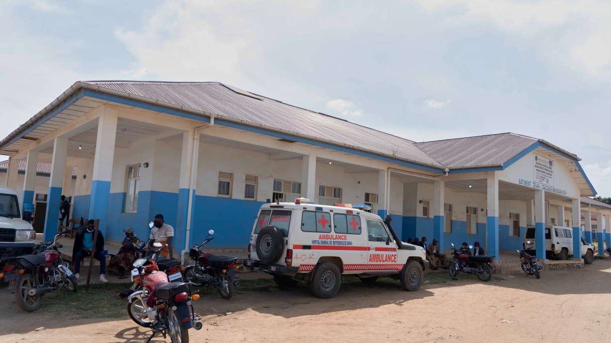 People wait near an ambulance at a hospital in Bunia, Congo, Sunday. Congo will open three treatment centers for the Ebola virus in the eastern Ituri province, and the World Health Organization is sending a team of experts to the country.