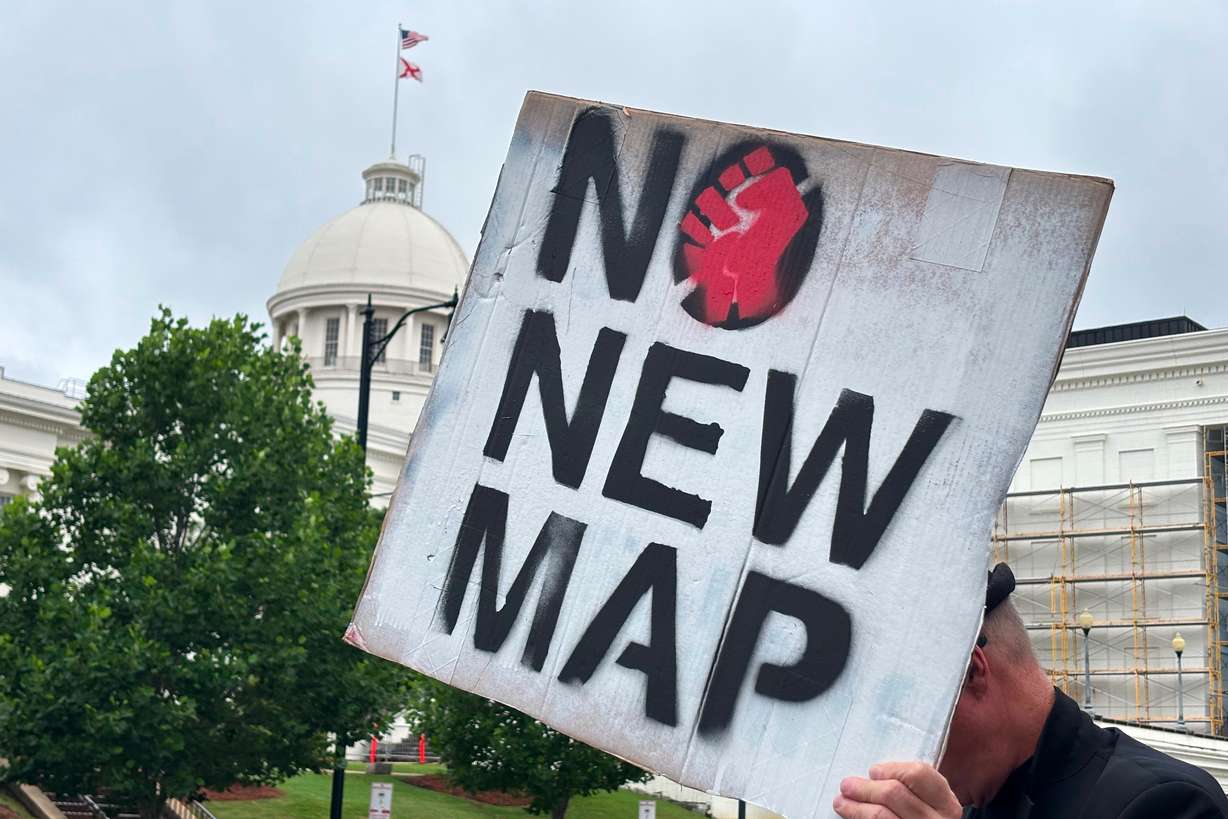 A demonstrator holds up a sign outside the Alabama Statehouse in Montgomery, Ala., on May 7. Votes in the primary elections were still cast as planned on Tuesday despite a redrawing of congressional districts underway in the state.