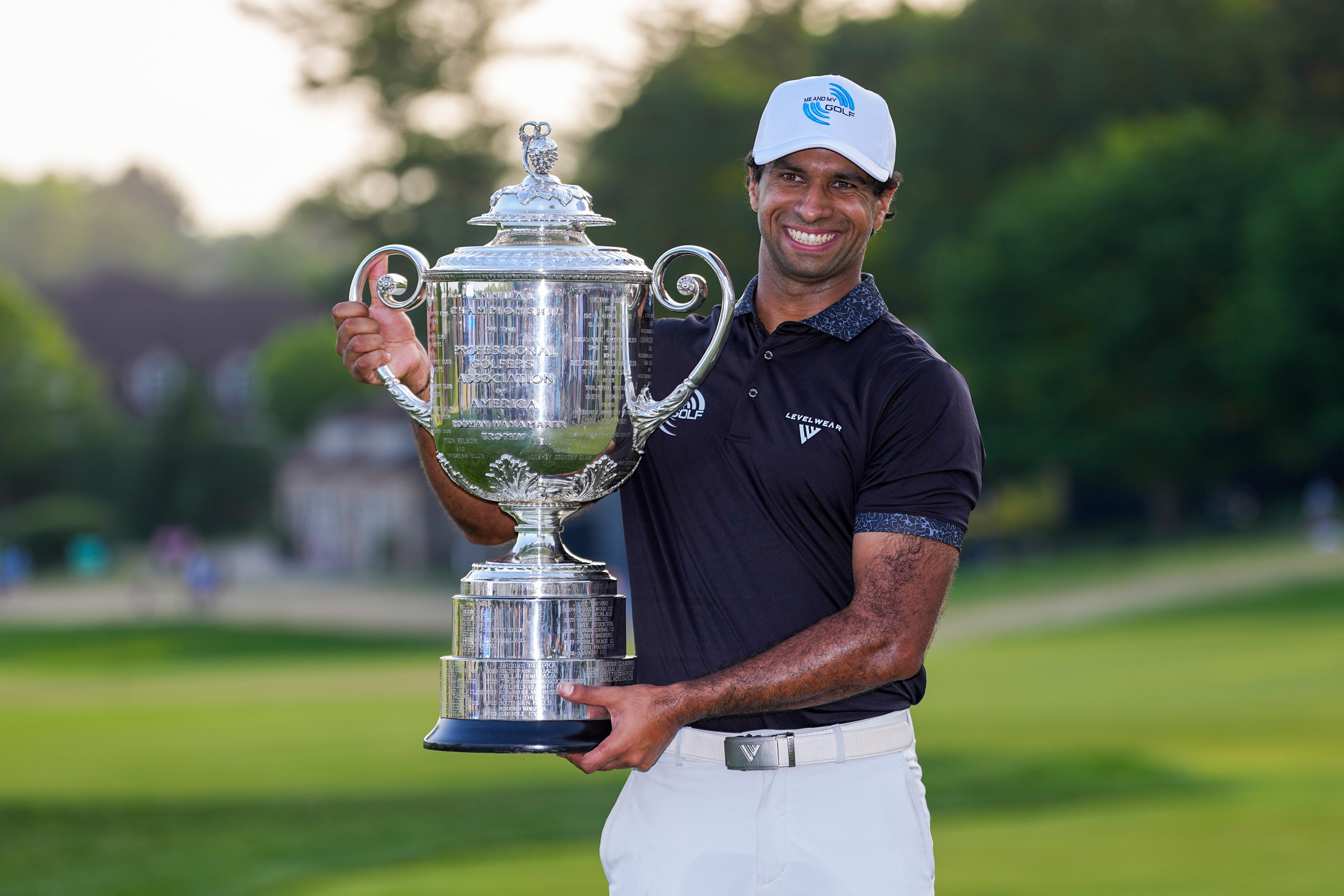 Aaron Rai, of England, holds the Wanamaker Trophy after winning the PGA Championship golf tournament at Aronimink Golf Club, Sunday, May 17, 2026, in Newtown Square, PA. 