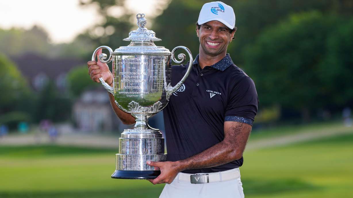 Aaron Rai, of England, holds the Wanamaker Trophy after winning the PGA Championship golf tournament at Aronimink Golf Club, Sunday, May 17, 2026, in Newtown Square, PA.