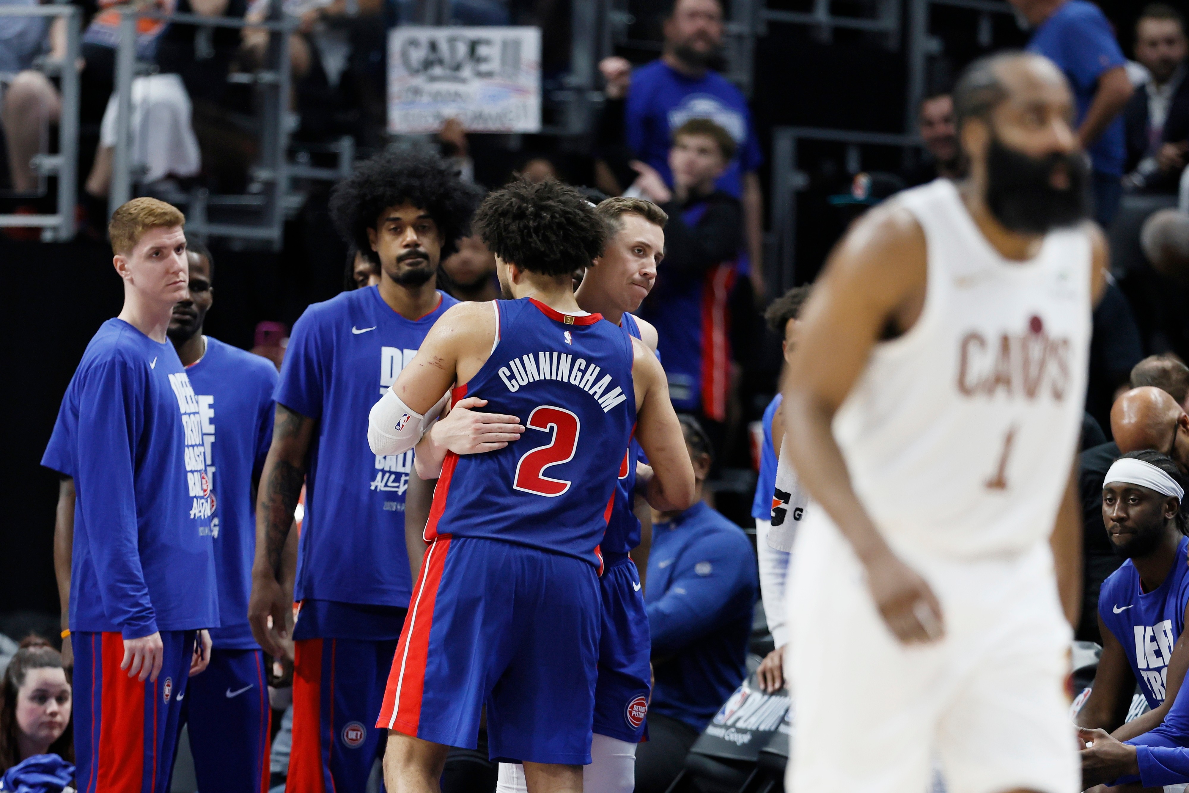 Detroit Pistons guard Cade Cunningham (2) is hugged by Duncan Robinson as Kevin Huerter, left, and Tolu Smith wait late in the fourth quarter of a loss to the Cleveland Cavaliers during Game 7 in a second-round NBA basketball playoffs series Sunday, May 17, 2026, in Detroit. 