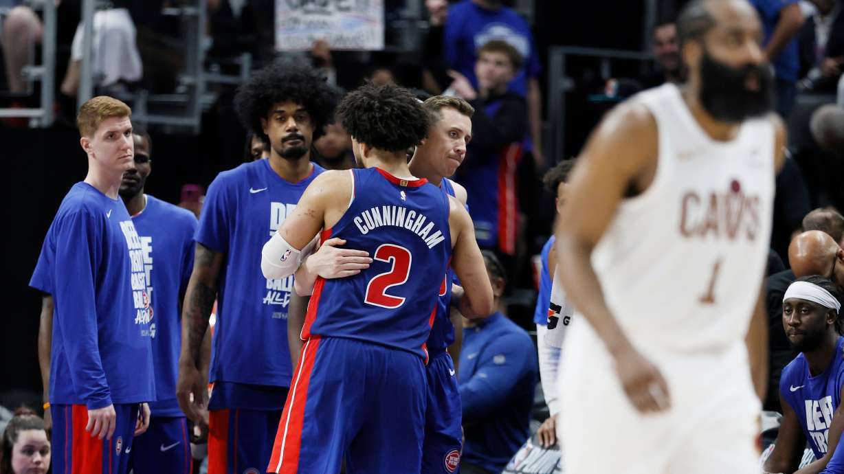 Detroit Pistons guard Cade Cunningham (2) is hugged by Duncan Robinson as Kevin Huerter, left, and Tolu Smith wait late in the fourth quarter of a loss to the Cleveland Cavaliers during Game 7 in a second-round NBA basketball playoffs series Sunday, May 17, 2026, in Detroit.