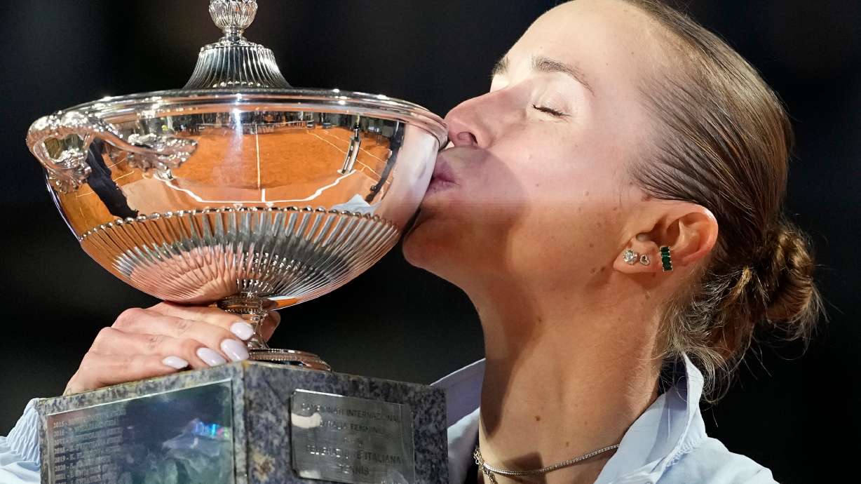 Ukraine's Elina Svitolina kisses the trophy after winning against United States' Coco Gauff at the end of the women's final match at the Italian Open tennis tournament in Rome, Saturday, May 16, 2026.