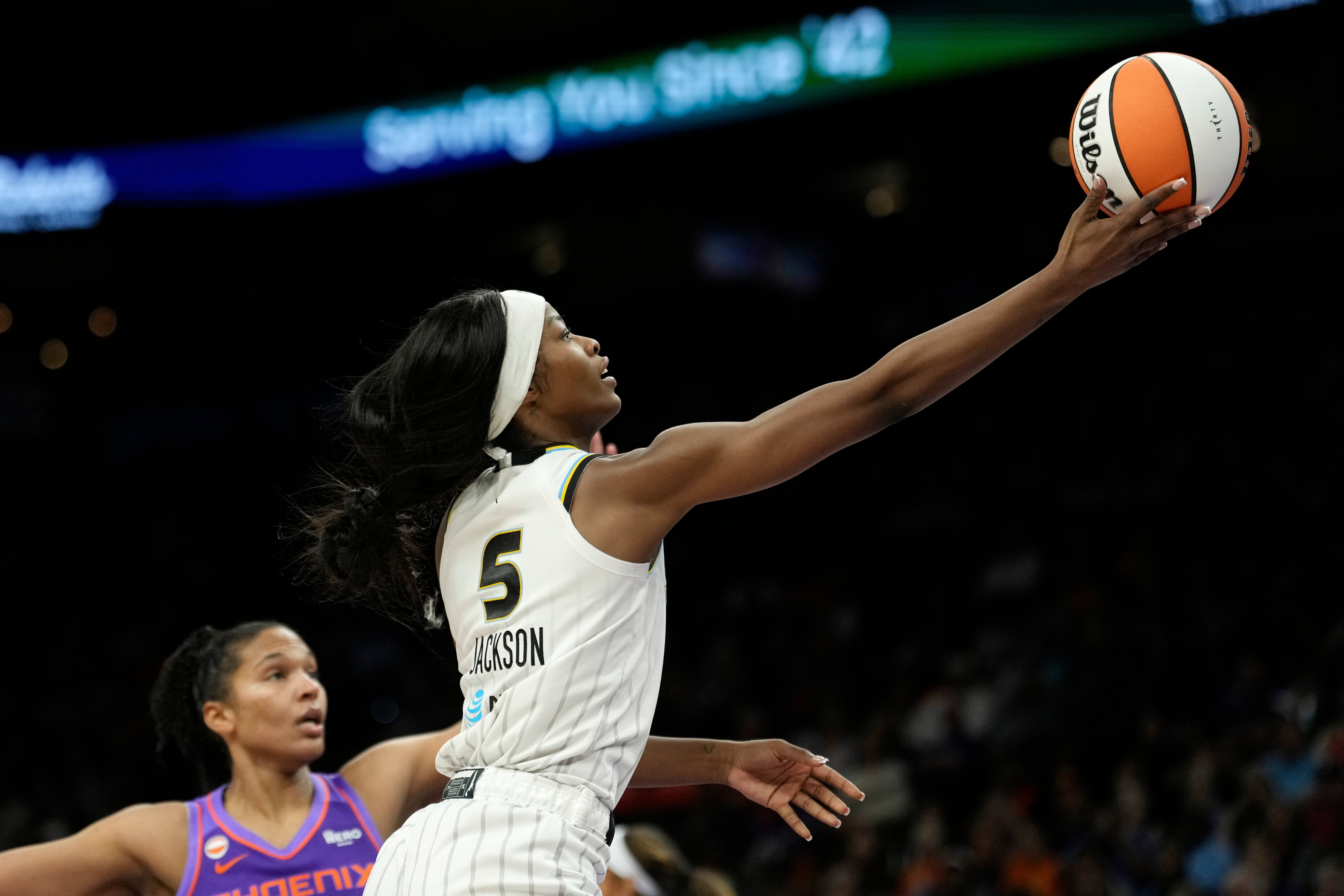 Chicago Sky forward Rickea Jackson (5) drives past Phoenix Mercury forward Alyssa Thomas to score during the second half of a WNBA basketball game, Friday, May 15, 2026, in Phoenix. 