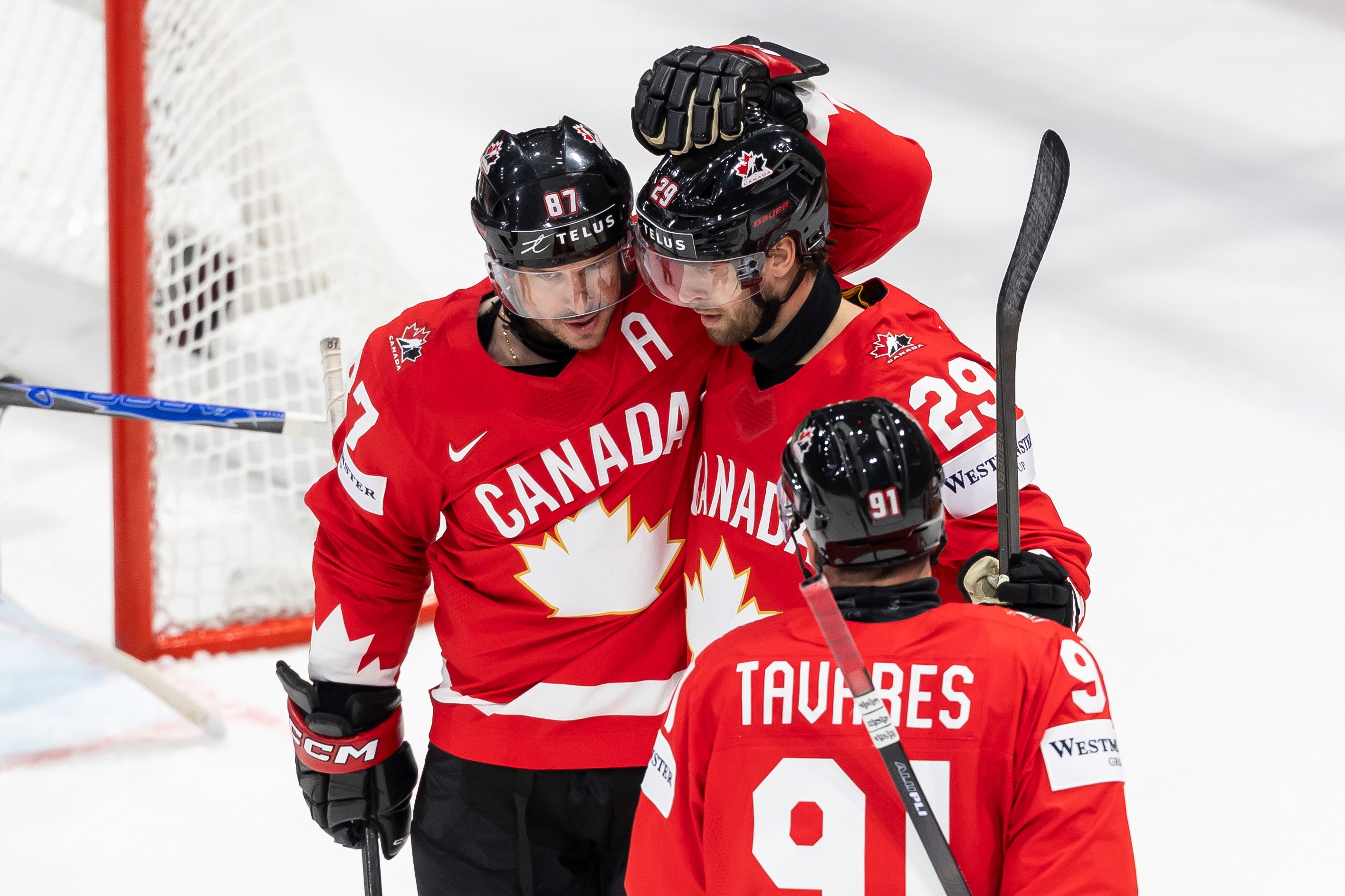 Canada's Parker Wotherspoon, center, celebrates his goal with Canada's Sidney Crosby, left, and Canada's John Tavares, right, during the 2026 IIHF Men's Ice Hockey World Championship preliminary round group B game between Canada and Denmark, in Fribourg, Switzerland, Monday, May 18, 2026. 