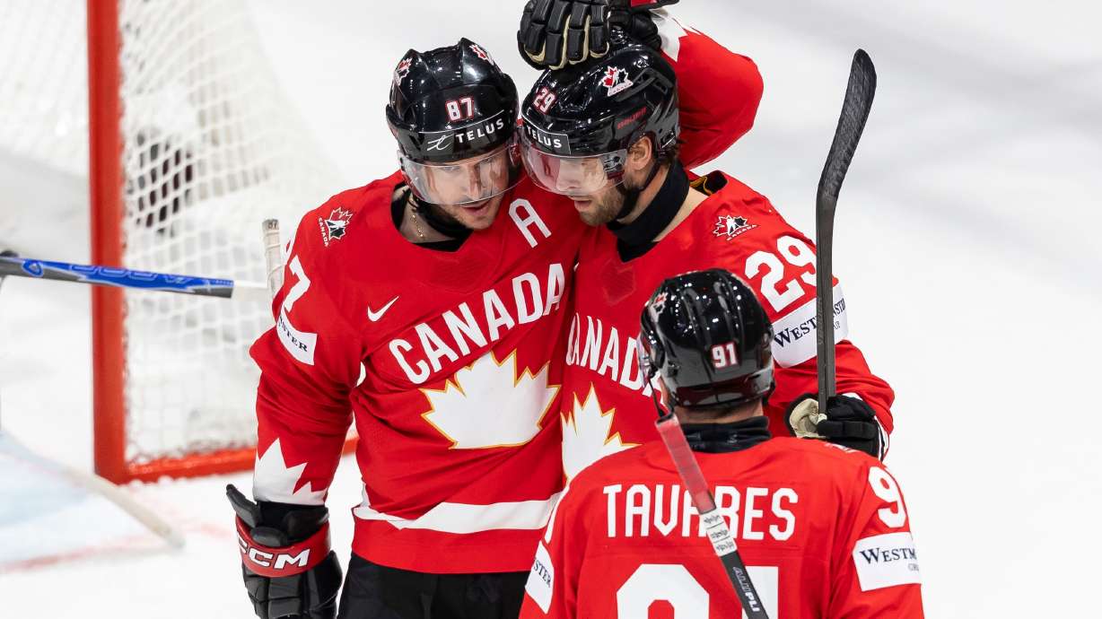 Canada's Parker Wotherspoon, center, celebrates his goal with Canada's Sidney Crosby, left, and Canada's John Tavares, right, during the 2026 IIHF Men's Ice Hockey World Championship preliminary round group B game between Canada and Denmark, in Fribourg, Switzerland, Monday, May 18, 2026.