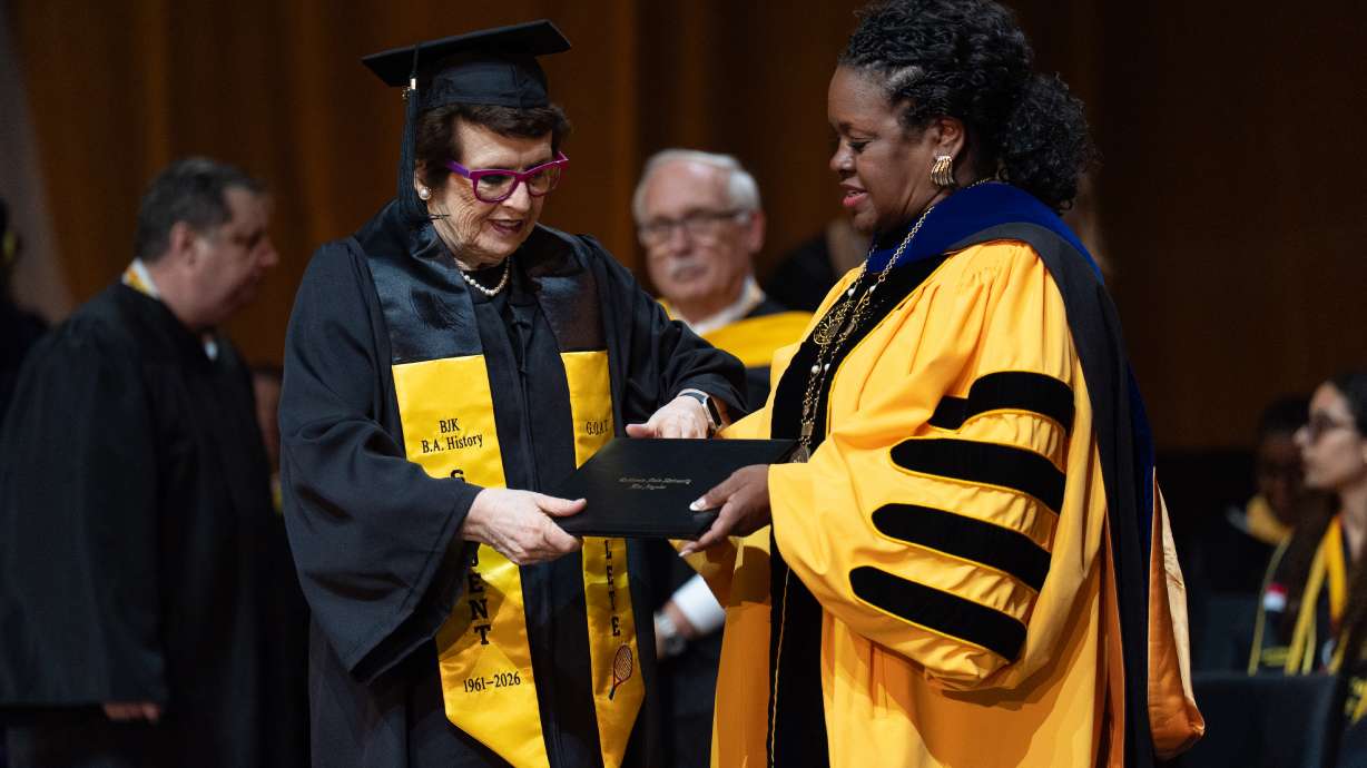 Tennis legend Billie Jean King, left, receives her diploma from California State University, Los Angeles, President Berenecea Johnson Eanes during commencement in Los Angeles, Monday, May 18, 2026.