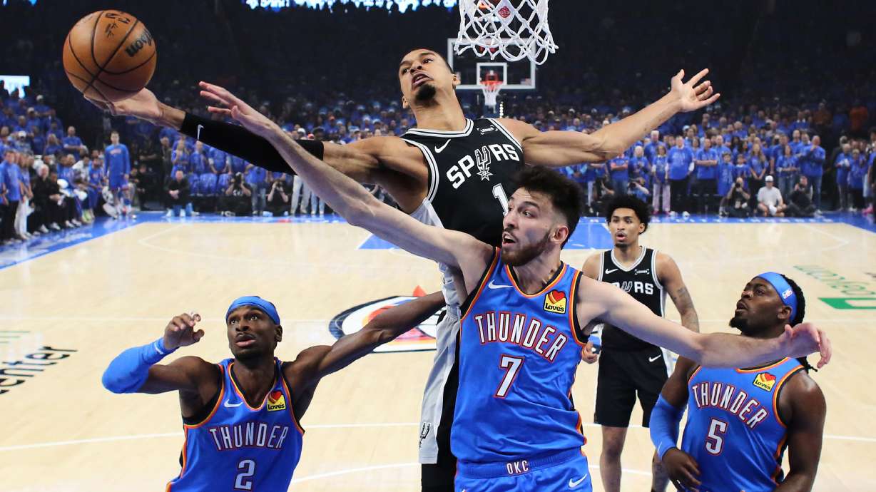 San Antonio Spurs forward Victor Wembanyama (1) and Oklahoma City Thunder center Chet Holmgren (7) reach for a rebound during the first half of Game 1 in a third-round NBA basketball playoffs series Monday, May 18, 2026, in Oklahoma City.