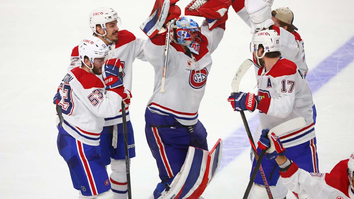 Montreal Canadiens players celebrate victory following the overtime period in Game 7 of a second-round NHL hockey Stanley Cup playoff series against the Buffalo Sabres, Monday, May 18, 2026, in Buffalo, N.Y.
