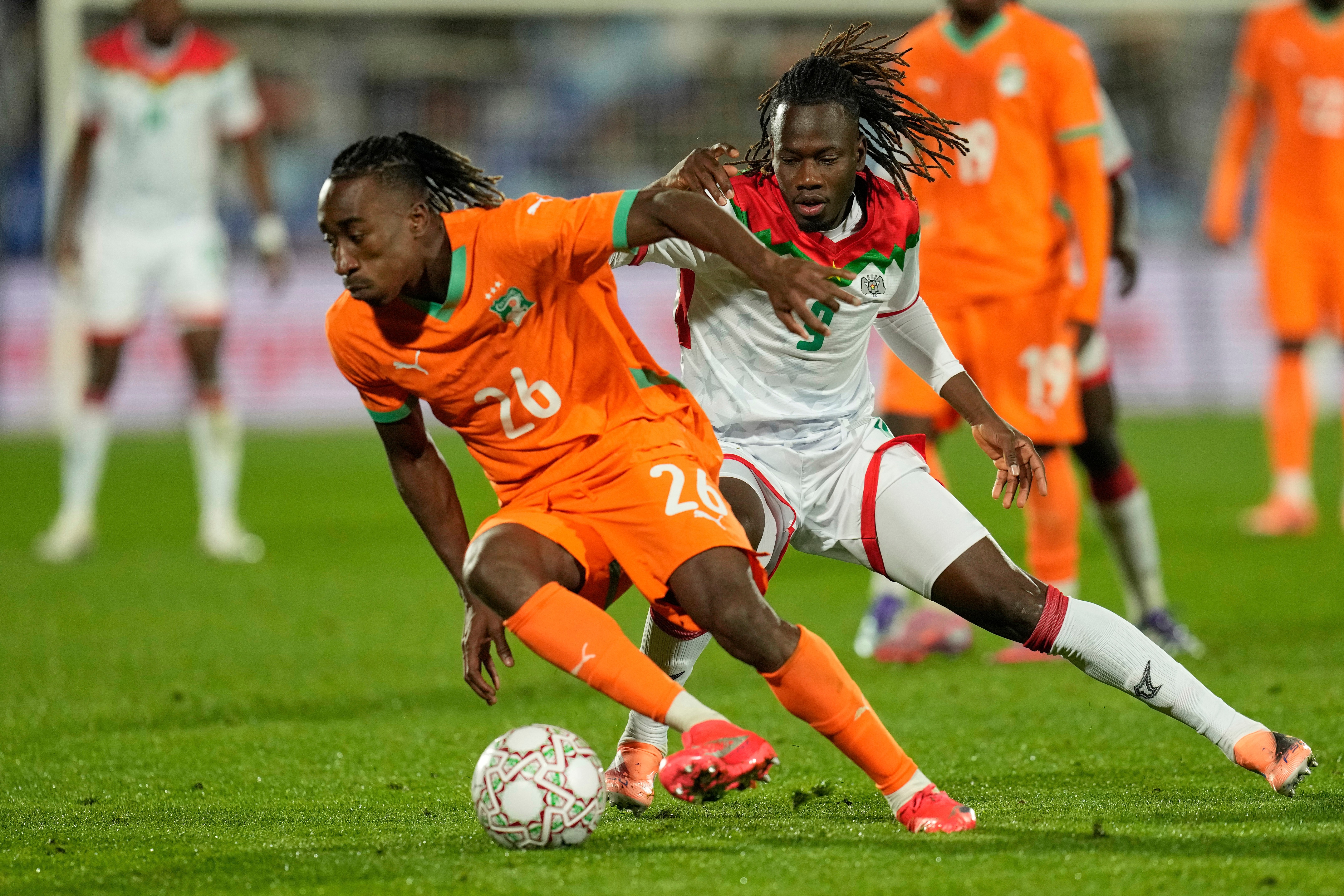 FILE - Ivory Coast's Yan Diomande, left, and Burkina Faso's Issa Kabore challenge during the Africa Cup of Nations best of 16 soccer match between Ivory Coast and Burkina Faso in Marrakech, Morocco, on Jan. 6, 2026. 