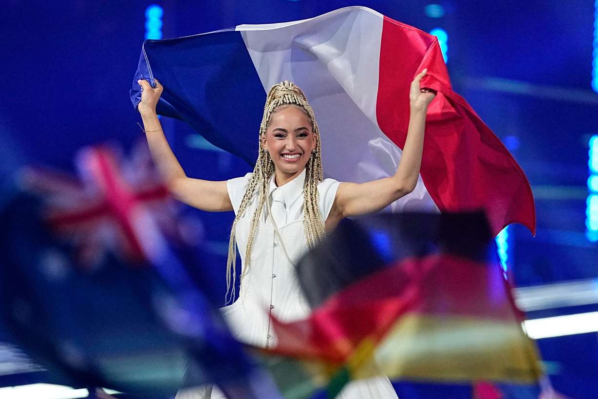 Monroe from France walks onto the stage carrying her country's flag ahead of the Grand Final of the 70th Eurovision Song Contest in Vienna, Austria, Saturday.