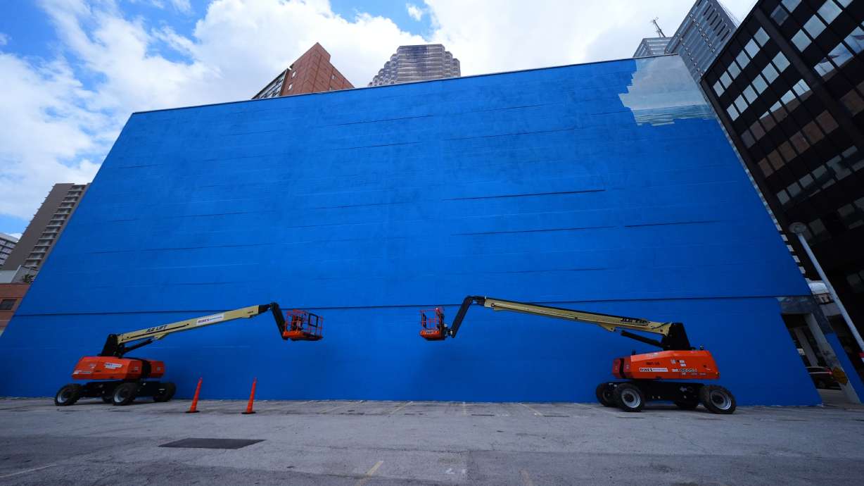 A mural, known as the "Whaling Wall 82," created by artist Wyland, is partially visible as it is painted over, Monday, May 18, 2026, in Dallas. CORRECTION: Corrects to mural being painted over