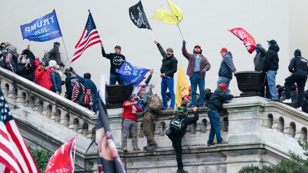 Rioters wave flags on the West Front of the U.S. Capitol in Washington on Jan. 6, 2021. Republican lawmakers are expressing skepticism about the Justice Department's creation of a $1.8 billion "anti-weaponization fund."
