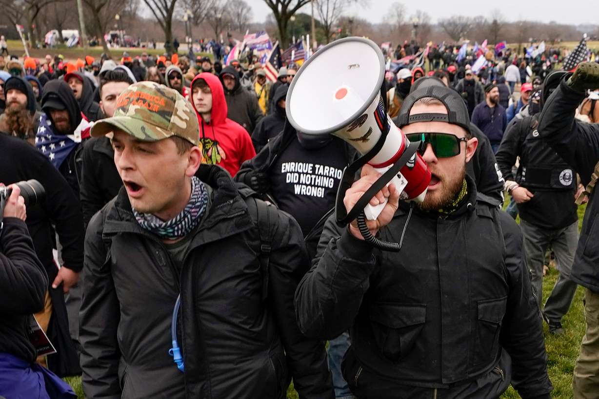 Proud Boys members Zachary Rehl, left, and Ethan Nordean, left, walk toward the U.S. Capitol in Washington, in support of President Donald Trump, Jan. 6, 2021. An upcoming hearing of the U.S. House Committee probing the Jan. 6 insurrection is expected to examine ties between people in former President Donald Trump's orbit and extremist groups who played a role in the Capitol riot.