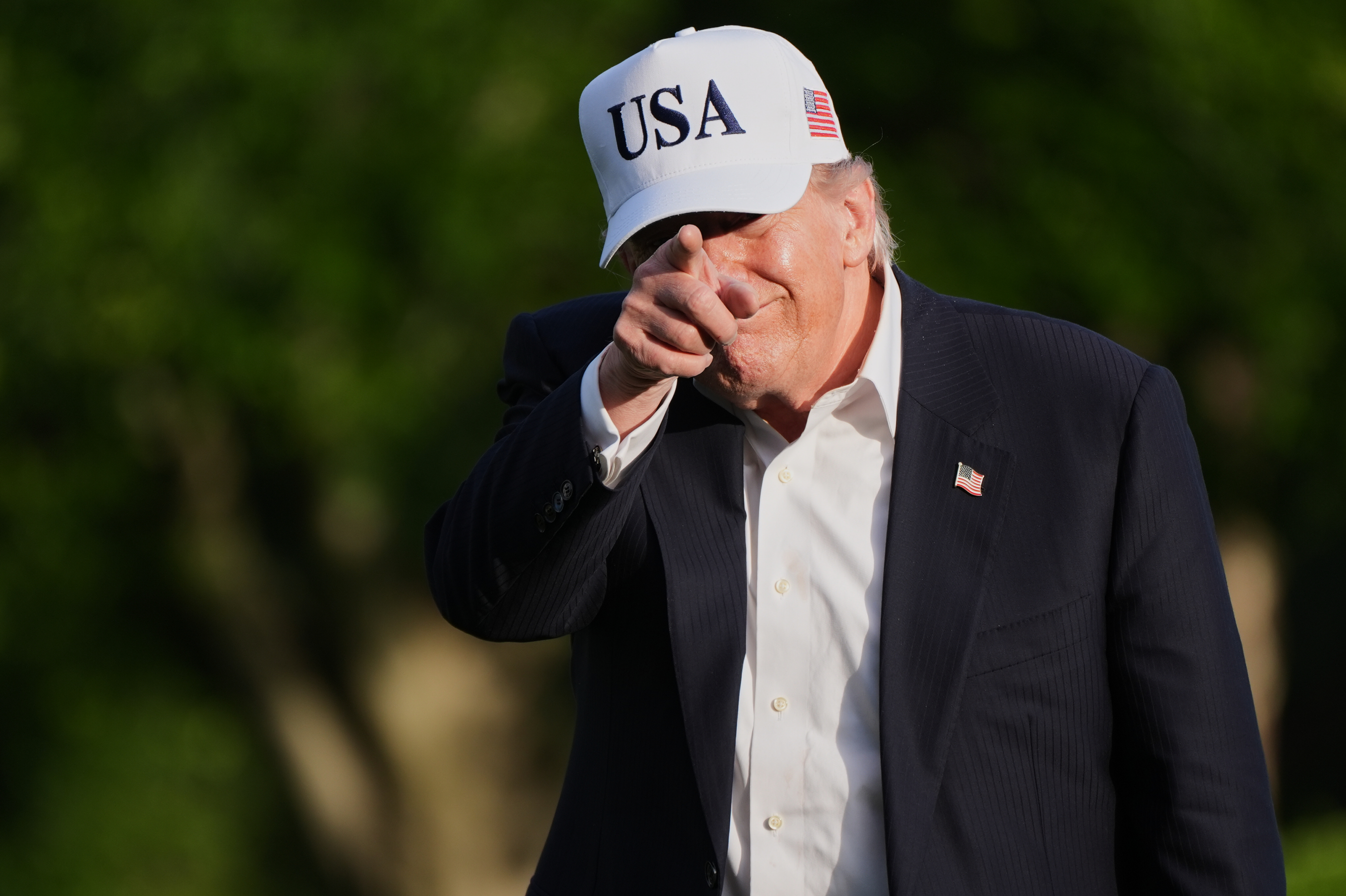 President Donald Trump walks across the South Lawn of the White House, Friday, in Washington. Trump is seeking to further tighten his influence over the Republican Party in Tuesday's primaries.