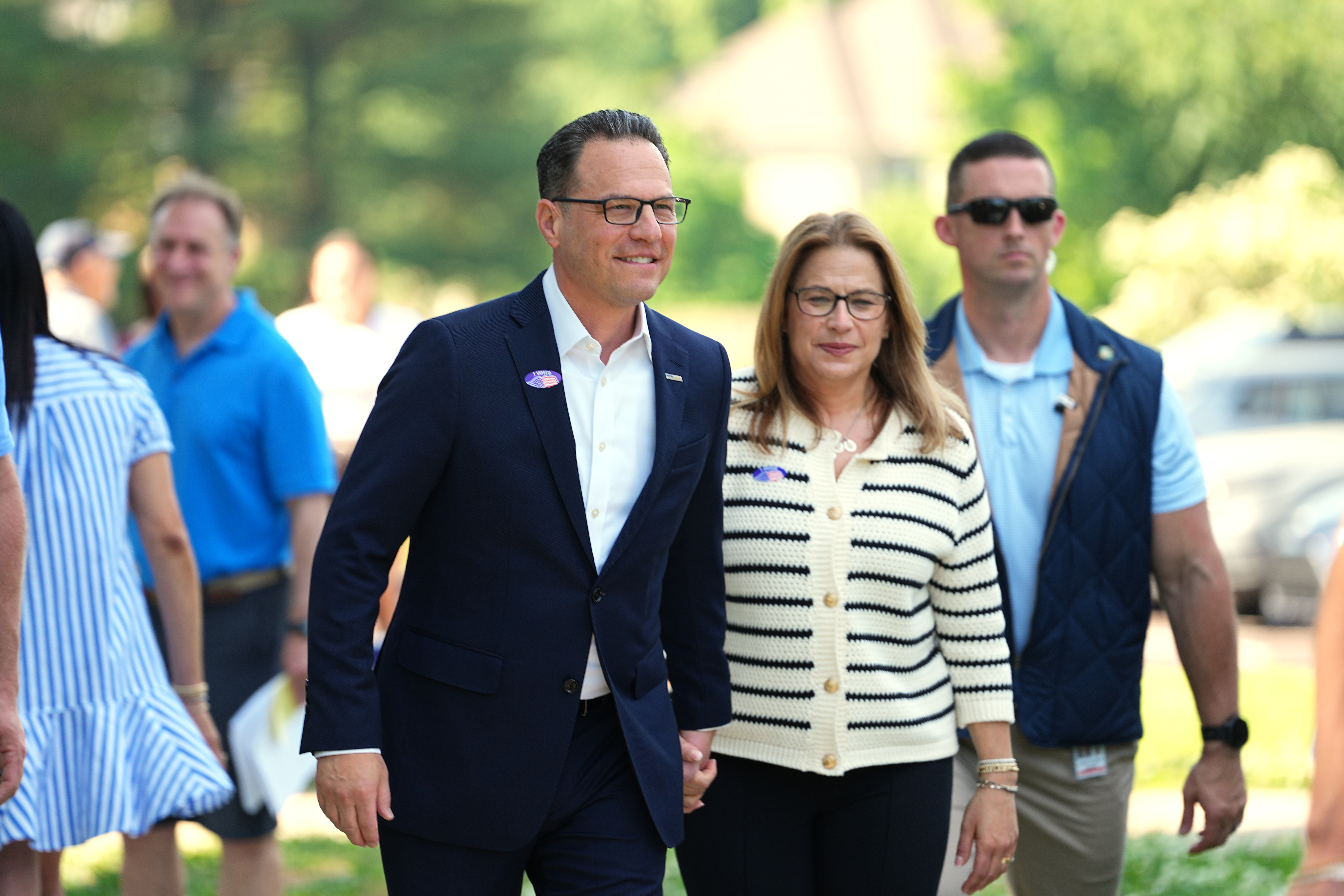 Pennsylvania Gov. Josh Shapiro, accompanied by his wife Lori Shapiro, walks from his polling place in Rydal, Pa., Tuesday. Shapiro's political clout is being tested as he is expected to be nominated as the Democratic gubernatorial candidate.