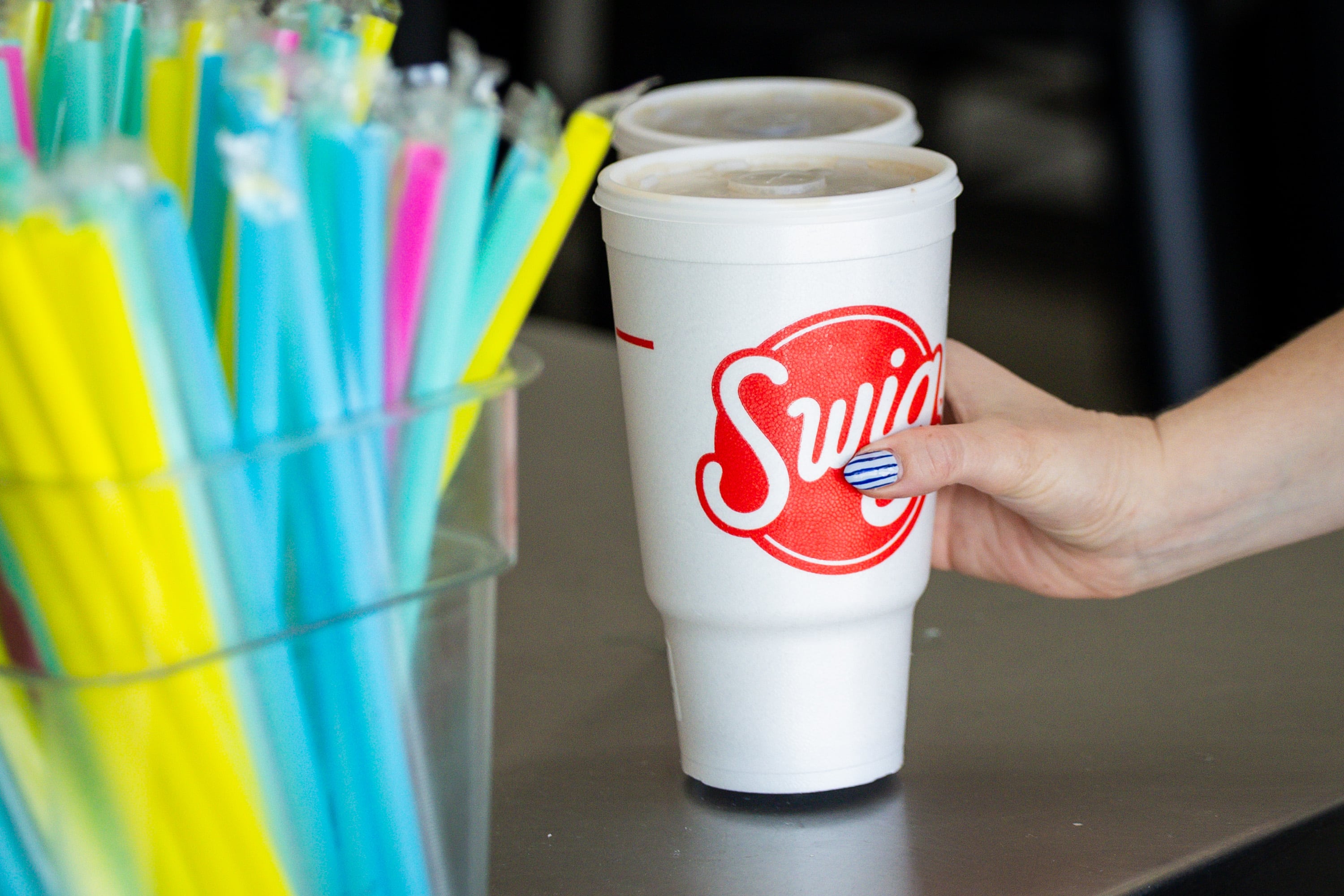 A customer grabs their drink at a Swig in South Jordan on March 12.