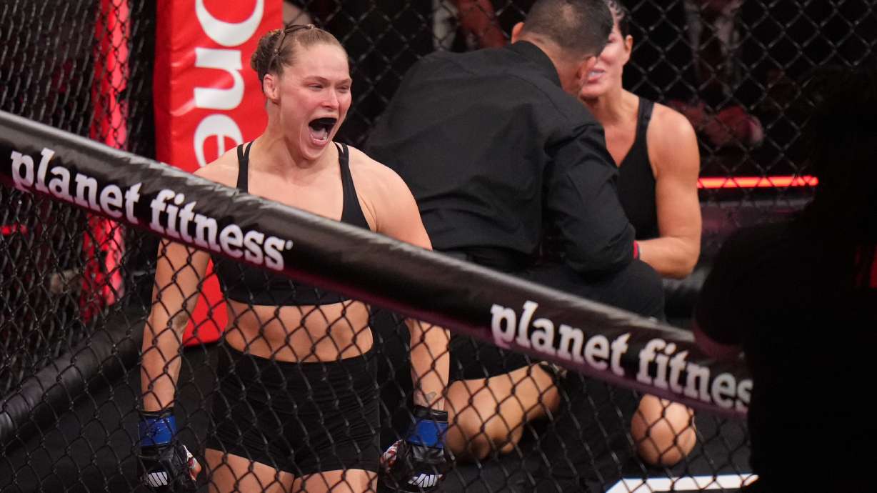 Ronda Rousey, of the United States, left, celebrates after defeating Gina Carano, of the United States, right, in their featherweight mixed martial arts fight Saturday, May 16, 2026, in Inglewood, Calif.