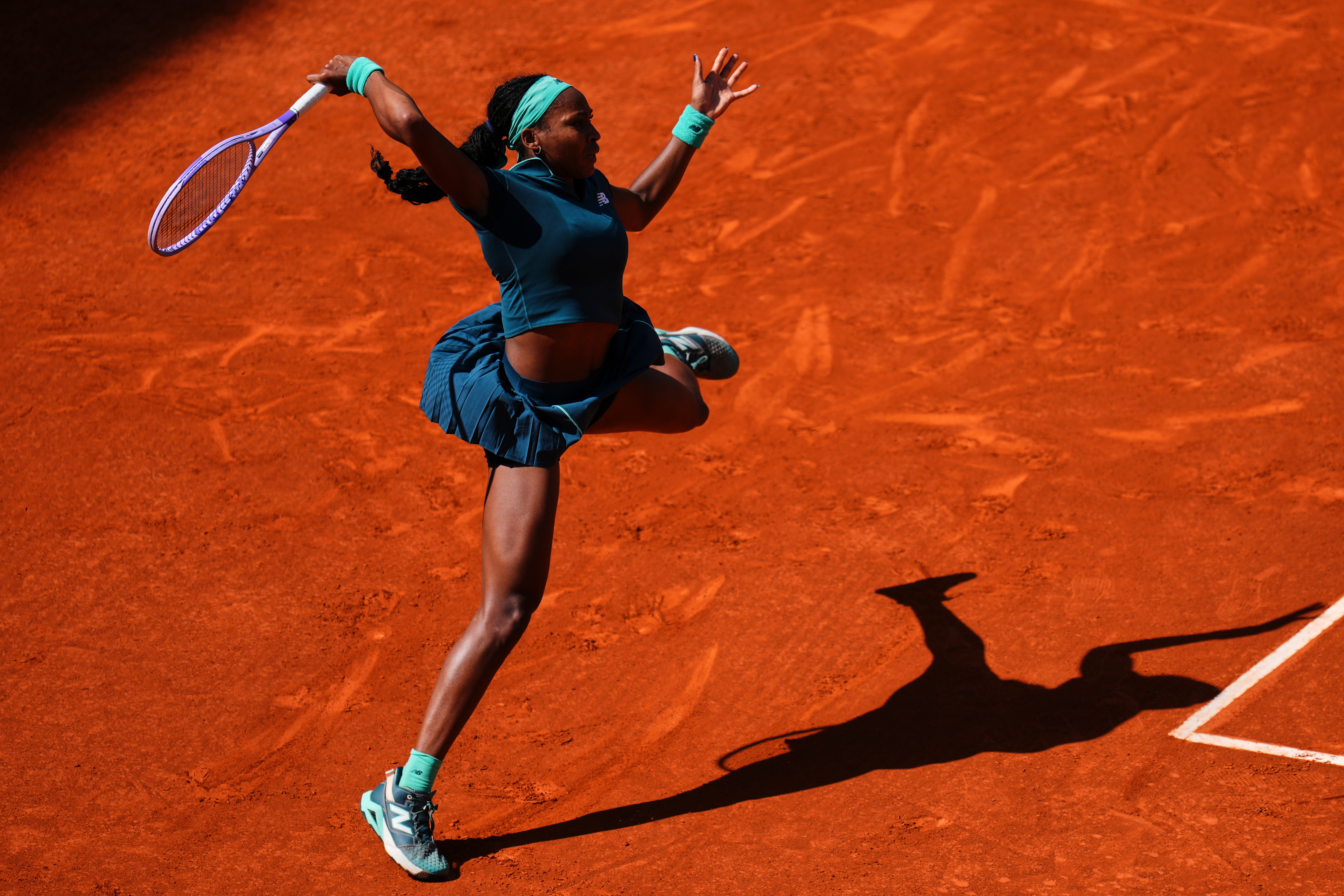 Coco Gauff of the U.S. returns the ball to Sorana Cirstea of Romania during the Madrid Open tennis tournament in Madrid, Sunday, April 26, 2026. 