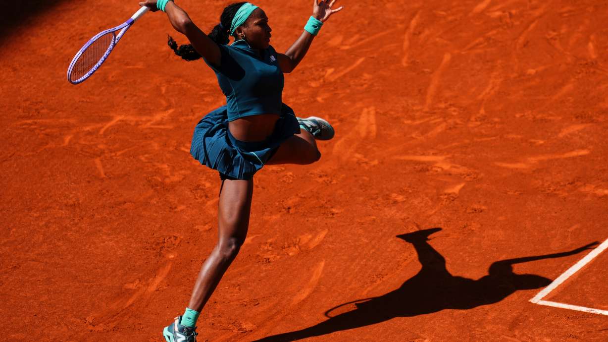 Coco Gauff of the U.S. returns the ball to Sorana Cirstea of Romania during the Madrid Open tennis tournament in Madrid, Sunday, April 26, 2026.