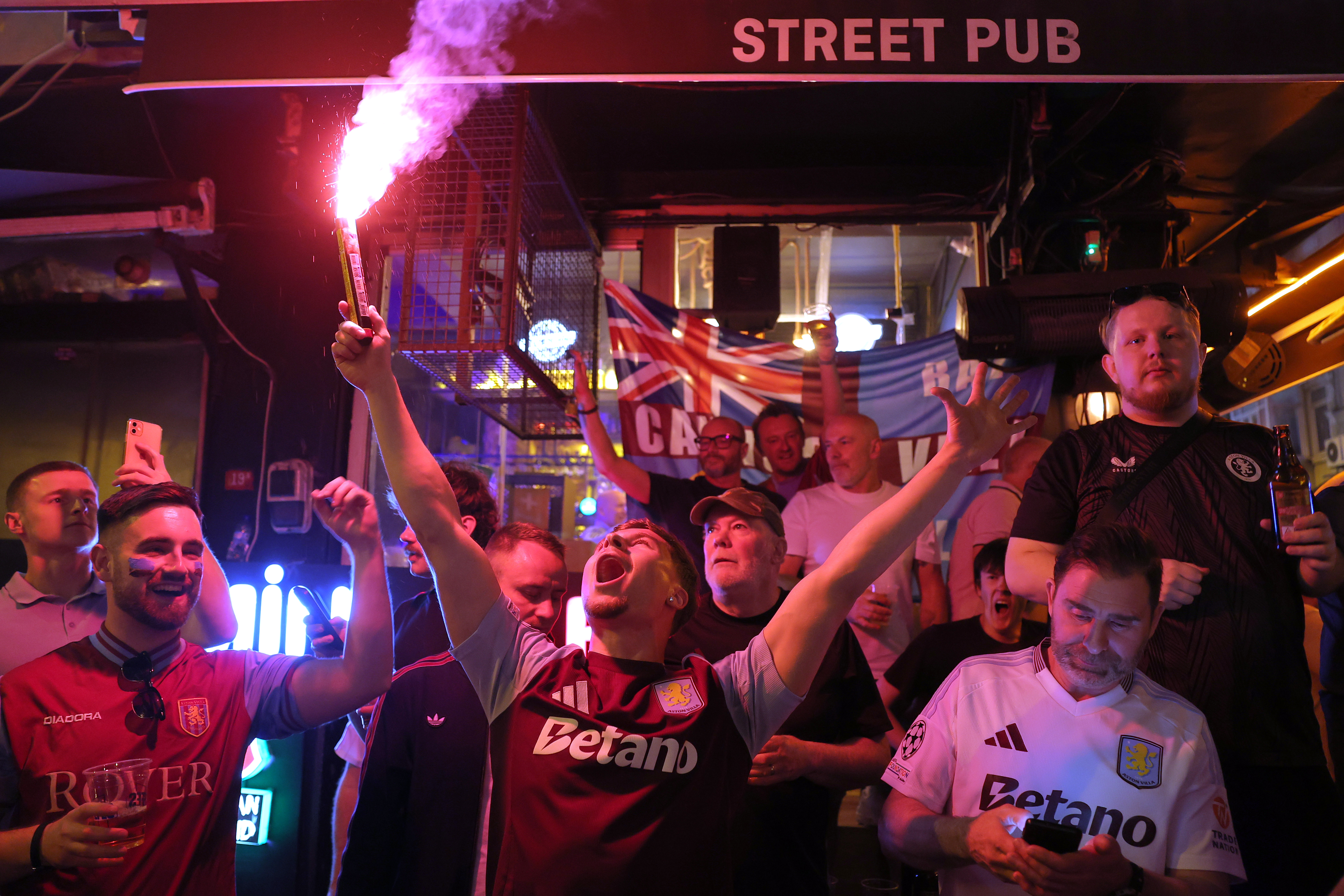 Aston Villa fans light flares and chant as they gather in the streets of Istanbul, Turkey, Tuesday, May 19, 2026, ahead of the Europa League final soccer match between Freiburg and Aston Villa.